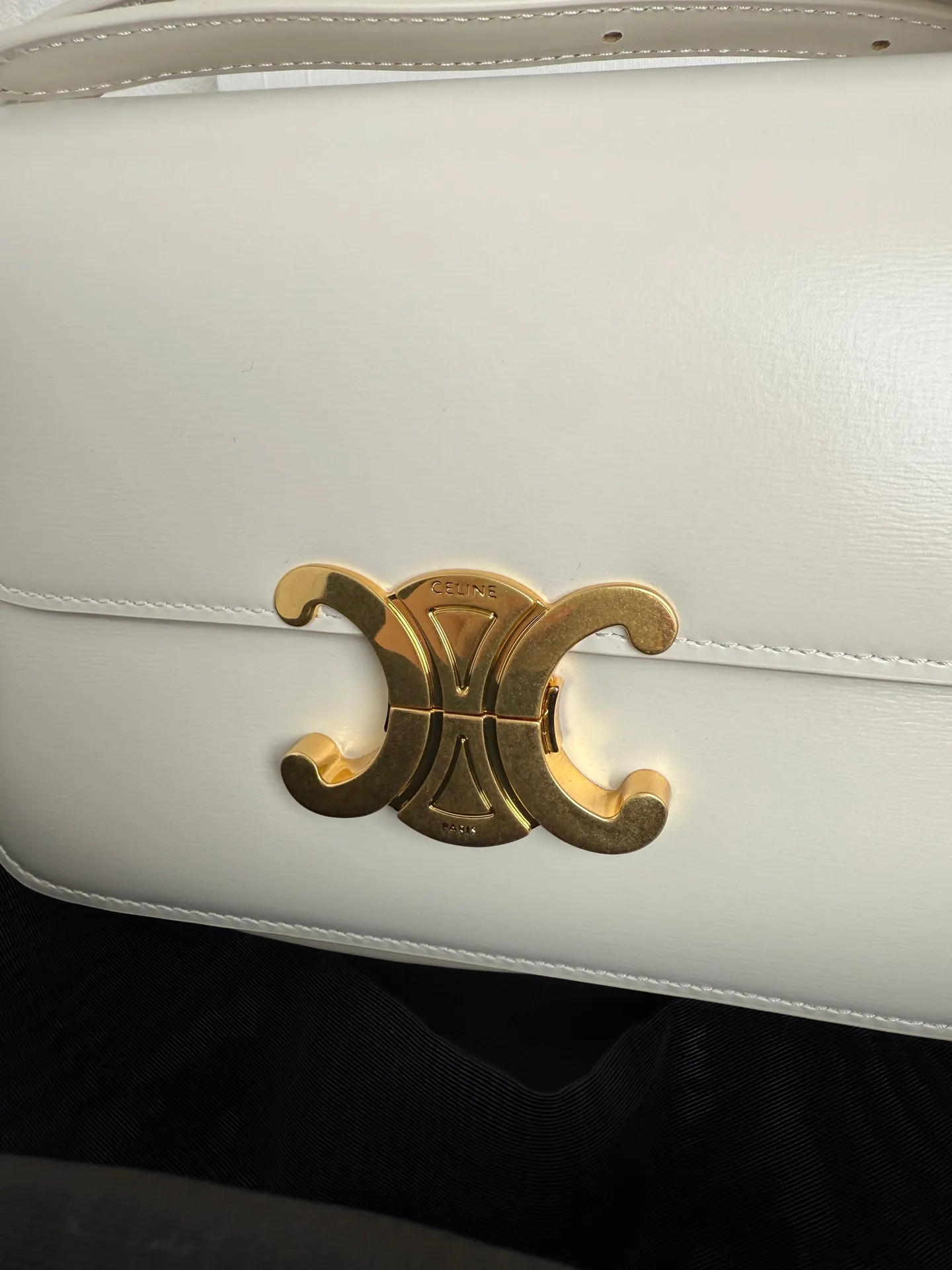 p1560. TEEN TRIOMPHE calfskin handbag This small TRIOMPHE handbag in satin calfskin comes with an adjustable leather shoulder strap and TRIOMPHE exclusive buckle TRIOMPHE brass lock interior zip pocket and interior flat pocket Adjustable leather shoulder strap Length 17 inches (42 cm) 7 X 6 X 2 inches (18.5 X 14 X 6 cm) No.: 188423