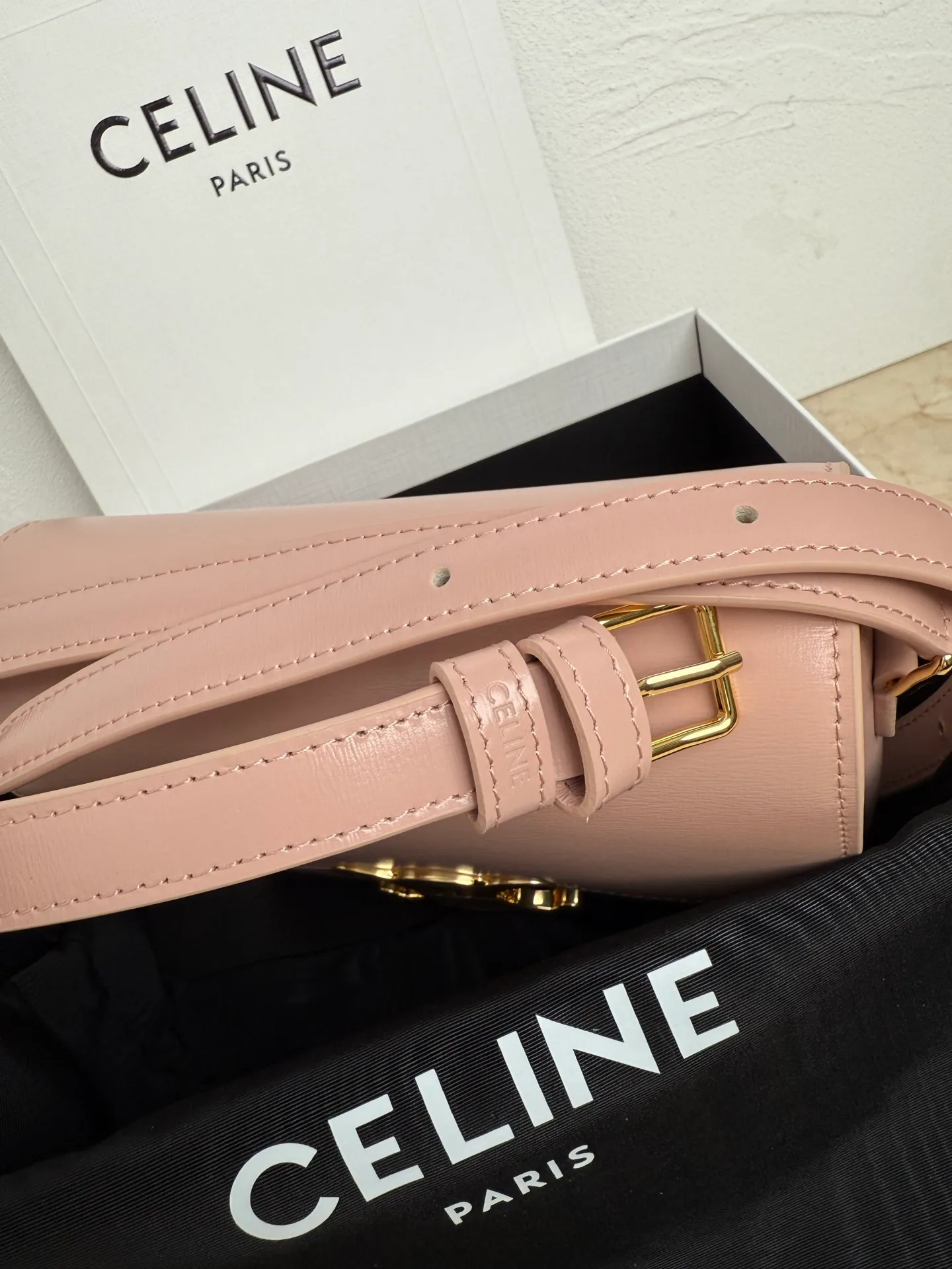 p1560. TEEN TRIOMPHE calfskin handbag This small TRIOMPHE handbag in satin calfskin comes with an adjustable leather shoulder strap and TRIOMPHE exclusive buckle TRIOMPHE brass lock interior zip pocket and interior flat pocket Adjustable leather shoulder strap Length 17 inches (42 cm) 7 X 6 X 2 inches (18.5 X 14 X 6 cm) No.: 188423