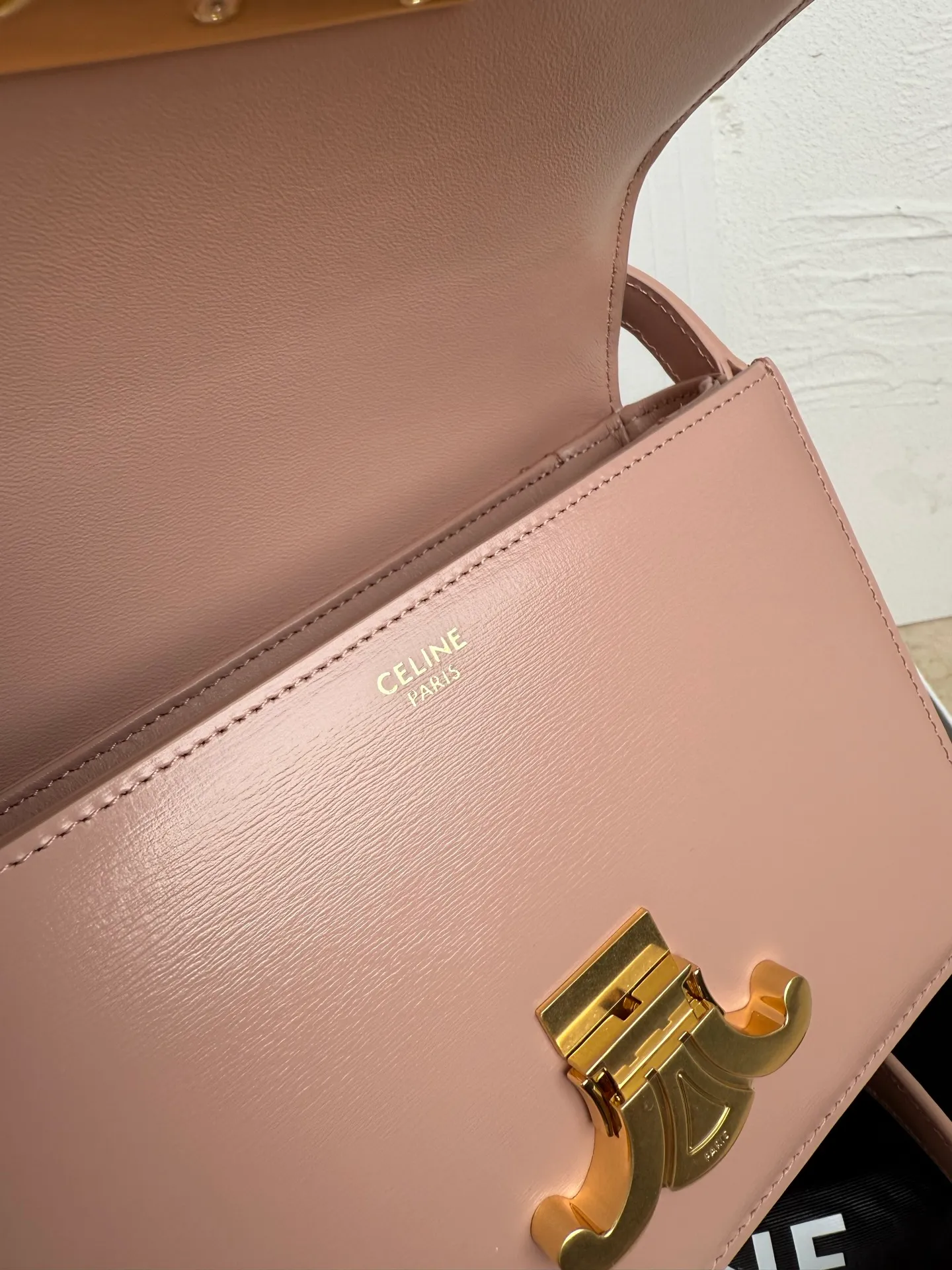 p1560. TEEN TRIOMPHE calfskin handbag This small TRIOMPHE handbag in satin calfskin comes with an adjustable leather shoulder strap and TRIOMPHE exclusive buckle TRIOMPHE brass lock interior zip pocket and interior flat pocket Adjustable leather shoulder strap Length 17 inches (42 cm) 7 X 6 X 2 inches (18.5 X 14 X 6 cm) No.: 188423