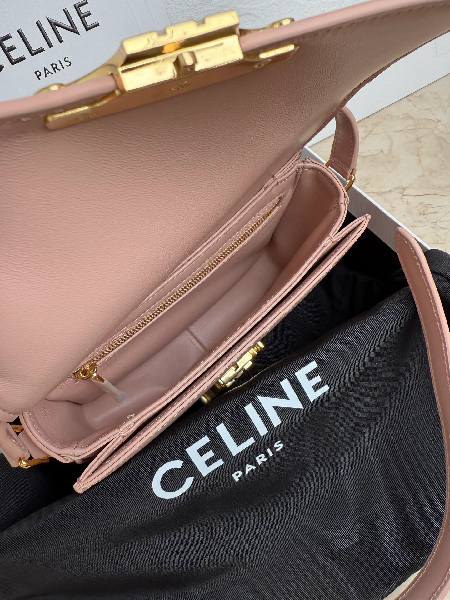 p1560. TEEN TRIOMPHE calfskin handbag This small TRIOMPHE handbag in satin calfskin comes with an adjustable leather shoulder strap and TRIOMPHE exclusive buckle TRIOMPHE brass lock interior zip pocket and interior flat pocket Adjustable leather shoulder strap Length 17 inches (42 cm) 7 X 6 X 2 inches (18.5 X 14 X 6 cm) No.: 188423