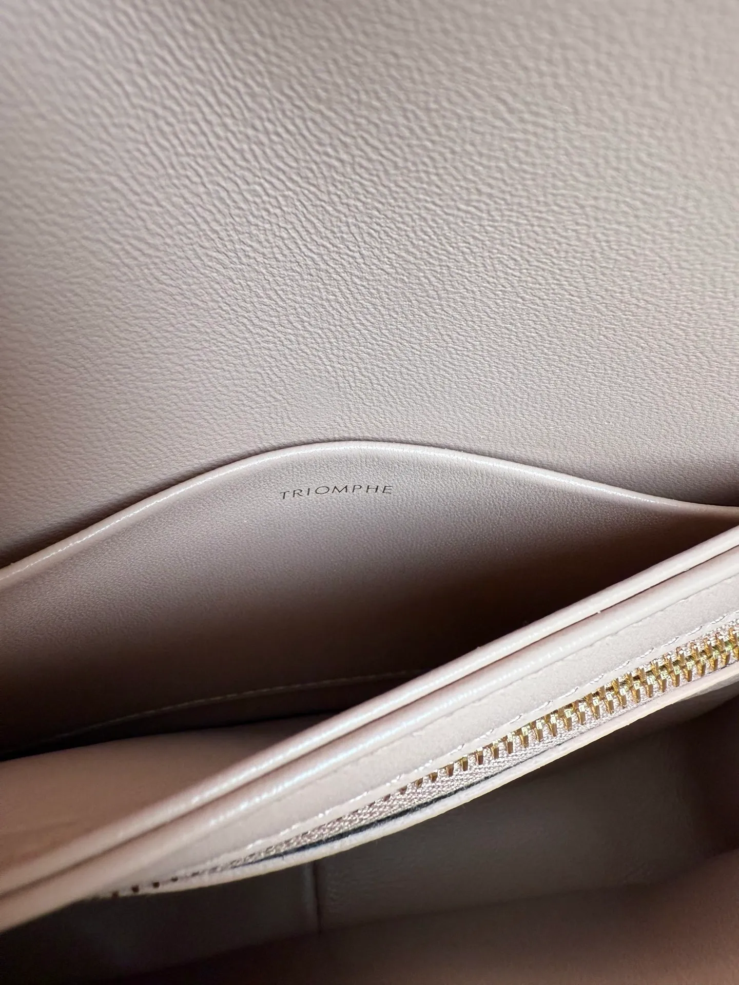 p1560. TEEN TRIOMPHE calfskin handbag This small TRIOMPHE handbag in satin calfskin comes with an adjustable leather shoulder strap and TRIOMPHE exclusive buckle TRIOMPHE brass lock interior zip pocket and interior flat pocket Adjustable leather shoulder strap Length 17 inches (42 cm) 7 X 6 X 2 inches (18.5 X 14 X 6 cm) No.: 188423