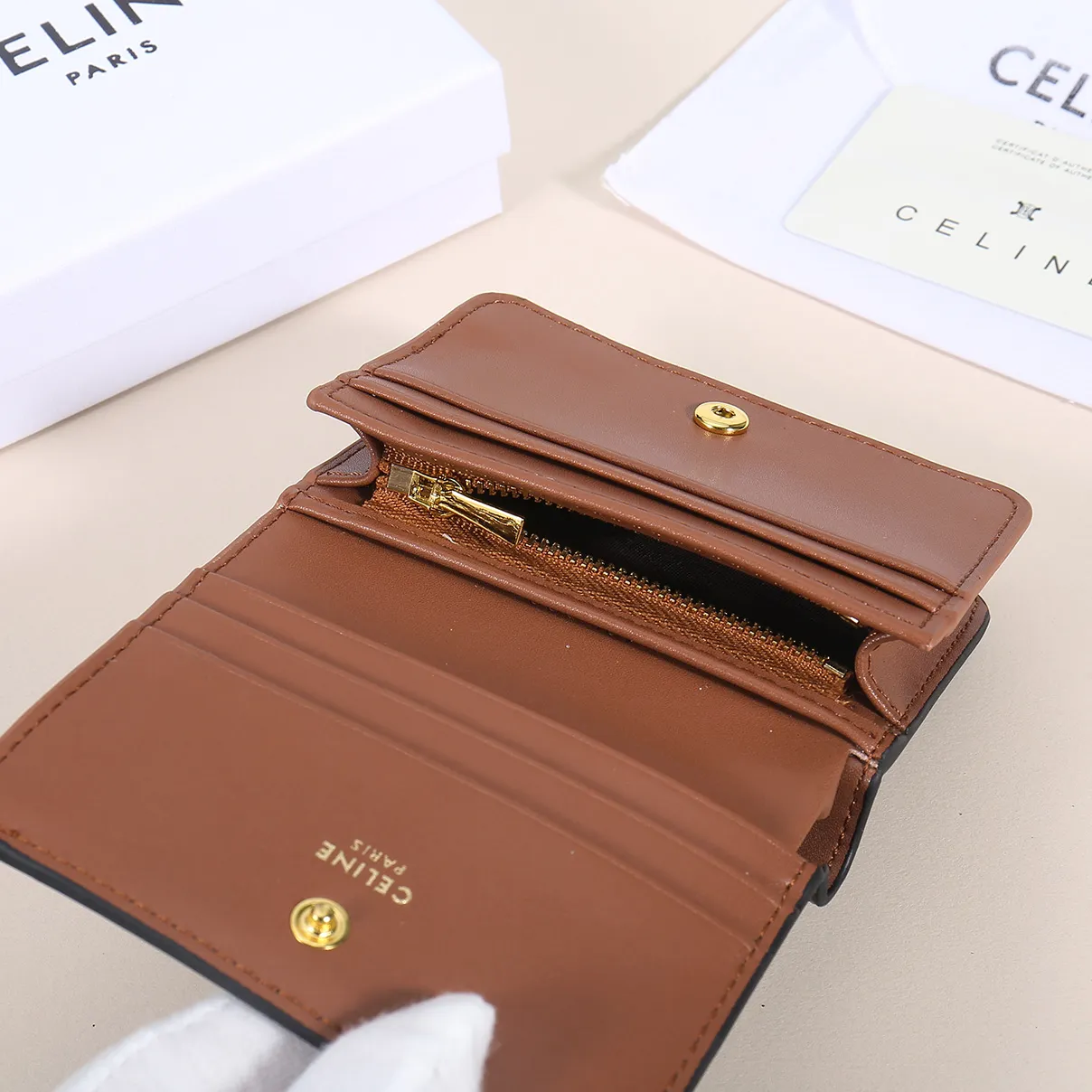 60. Celine classic card holder, TRIOMPHE business card holder, large cowhide interior with plain microfiber TRIOMPHE CANVAS logo print, gold finish TRIOMPHE metal snap closure, 1 zipper coin pocket, 5 card slots, 1 banknote pocket, 1 flat pocket No.: 10K623 Size: 11 X 9 X 3 cm