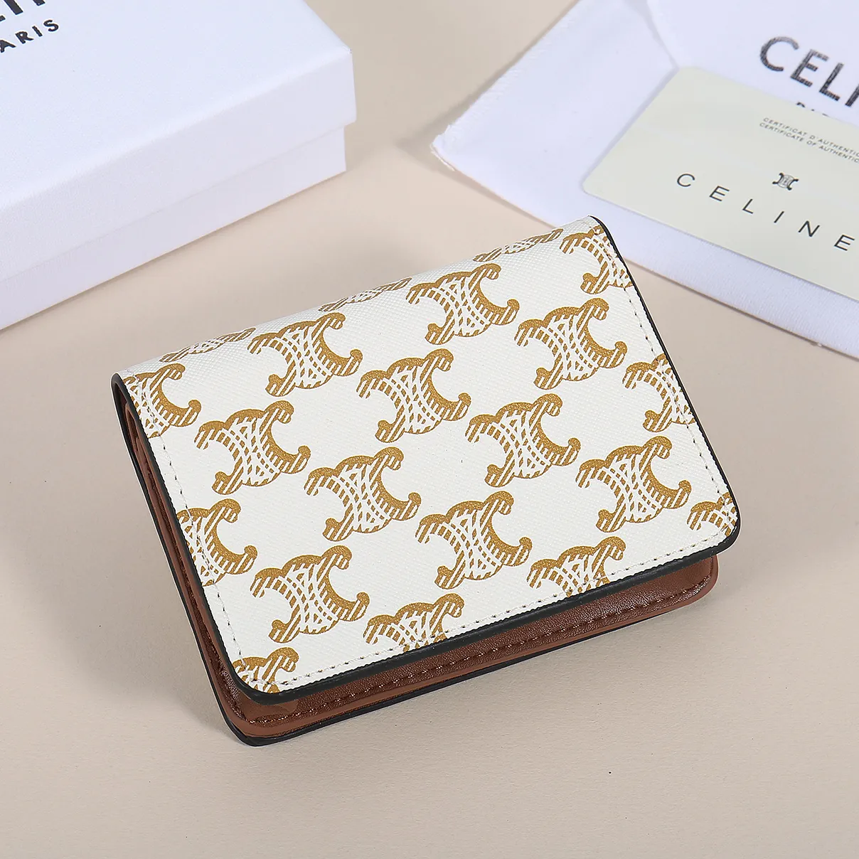 60. Celine classic card holder, TRIOMPHE business card holder, large cowhide interior with plain microfiber TRIOMPHE CANVAS logo print, gold finish TRIOMPHE metal snap closure, 1 zipper coin pocket, 5 card slots, 1 banknote pocket, 1 flat pocket No.: 10K623 Size: 11 X 9 X 3 cm