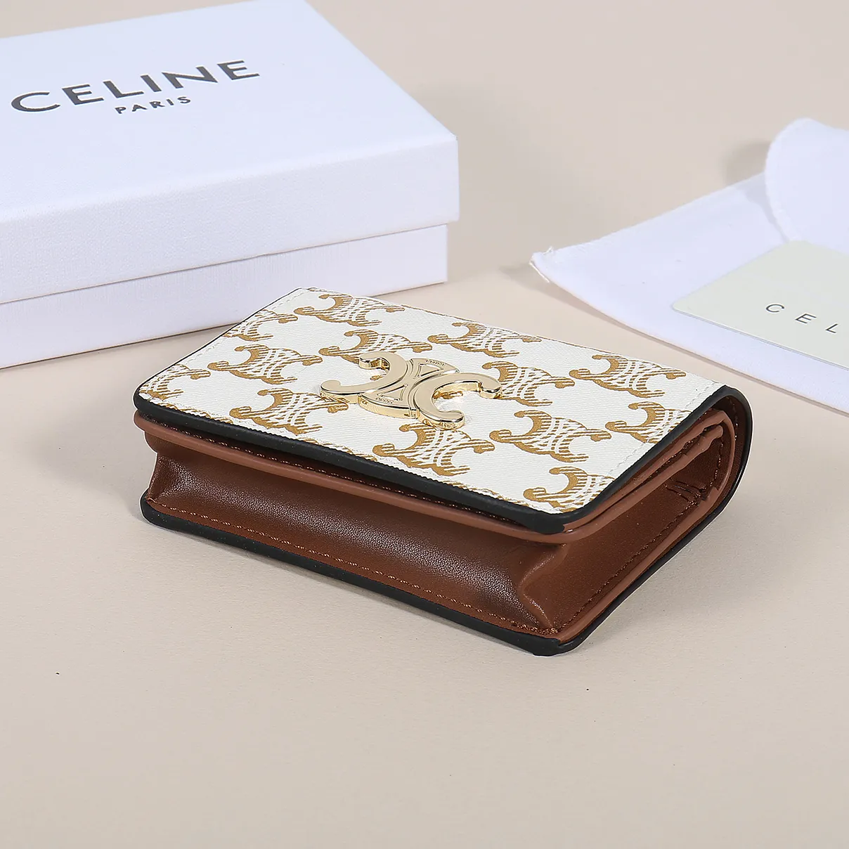 60. Celine classic card holder, TRIOMPHE business card holder, large cowhide interior with plain microfiber TRIOMPHE CANVAS logo print, gold finish TRIOMPHE metal snap closure, 1 zipper coin pocket, 5 card slots, 1 banknote pocket, 1 flat pocket No.: 10K623 Size: 11 X 9 X 3 cm