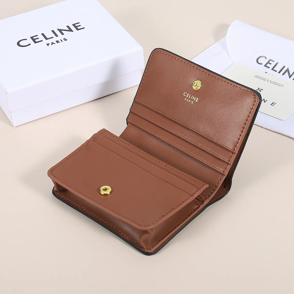 60. Celine classic card holder, TRIOMPHE business card holder, large cowhide interior with plain microfiber TRIOMPHE CANVAS logo print, gold finish TRIOMPHE metal snap closure, 1 zipper coin pocket, 5 card slots, 1 banknote pocket, 1 flat pocket No.: 10K623 Size: 11 X 9 X 3 cm