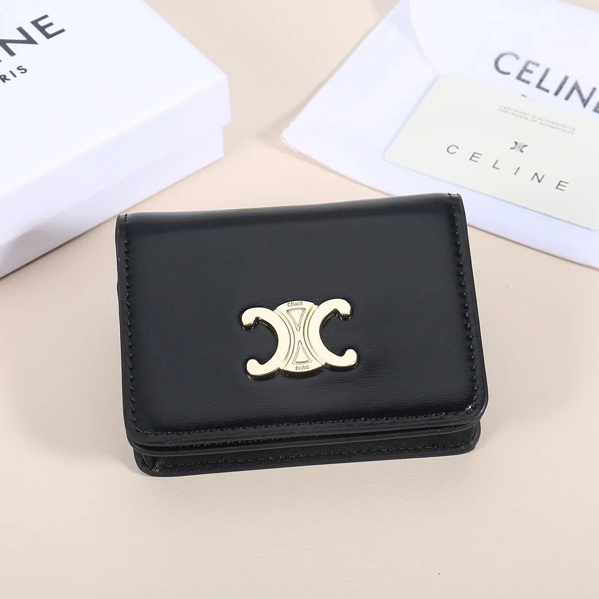 60. Celine classic card holder, TRIOMPHE business card holder, large cowhide interior with plain microfiber TRIOMPHE CANVAS logo print, gold finish TRIOMPHE metal snap closure, 1 zipper coin pocket, 5 card slots, 1 banknote pocket, 1 flat pocket No.: 10K623 Size: 11 X 9 X 3 cm