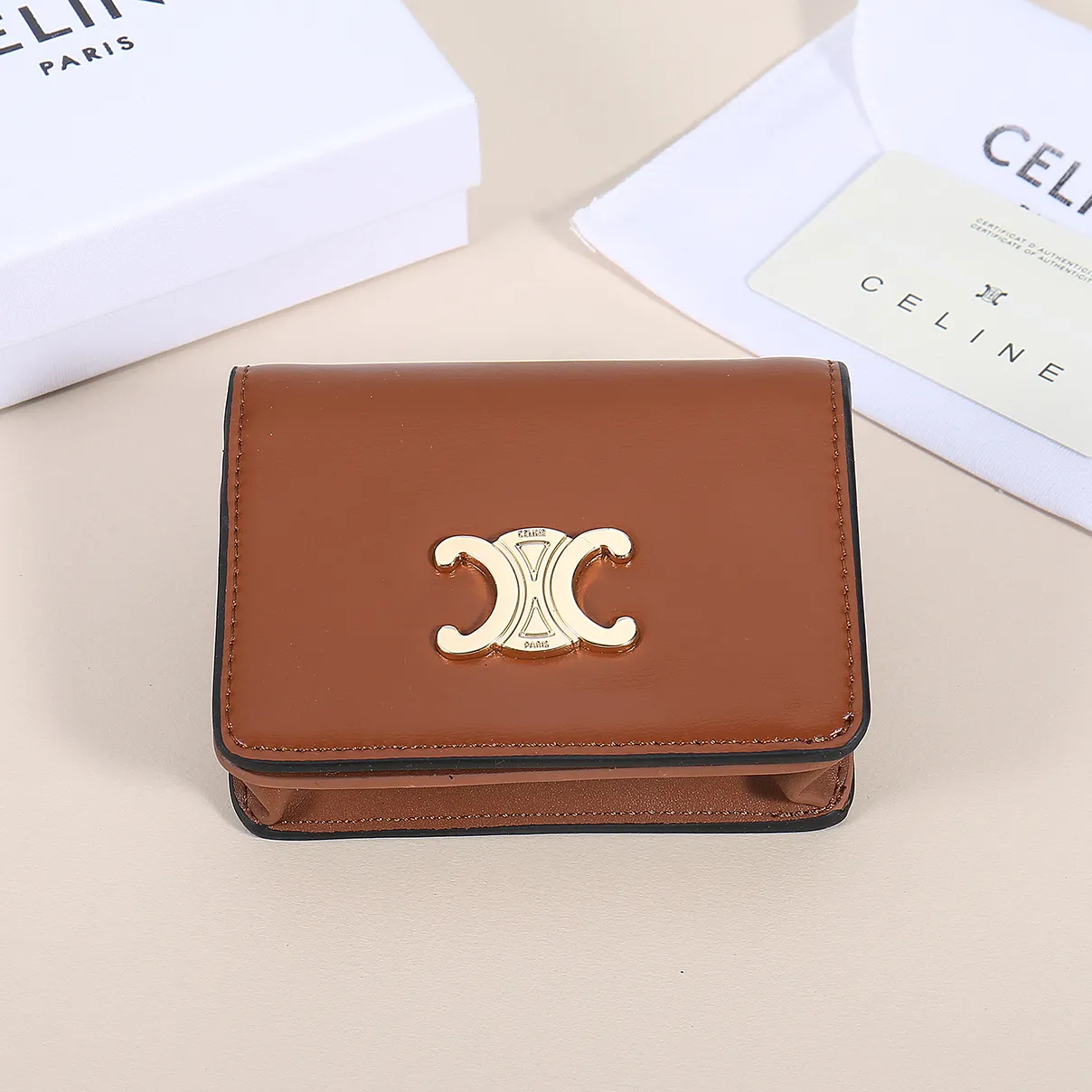 60. Celine classic card holder, TRIOMPHE business card holder, large cowhide interior with plain microfiber TRIOMPHE CANVAS logo print, gold finish TRIOMPHE metal snap closure, 1 zipper coin pocket, 5 card slots, 1 banknote pocket, 1 flat pocket No.: 10K623 Size: 11 X 9 X 3 cm