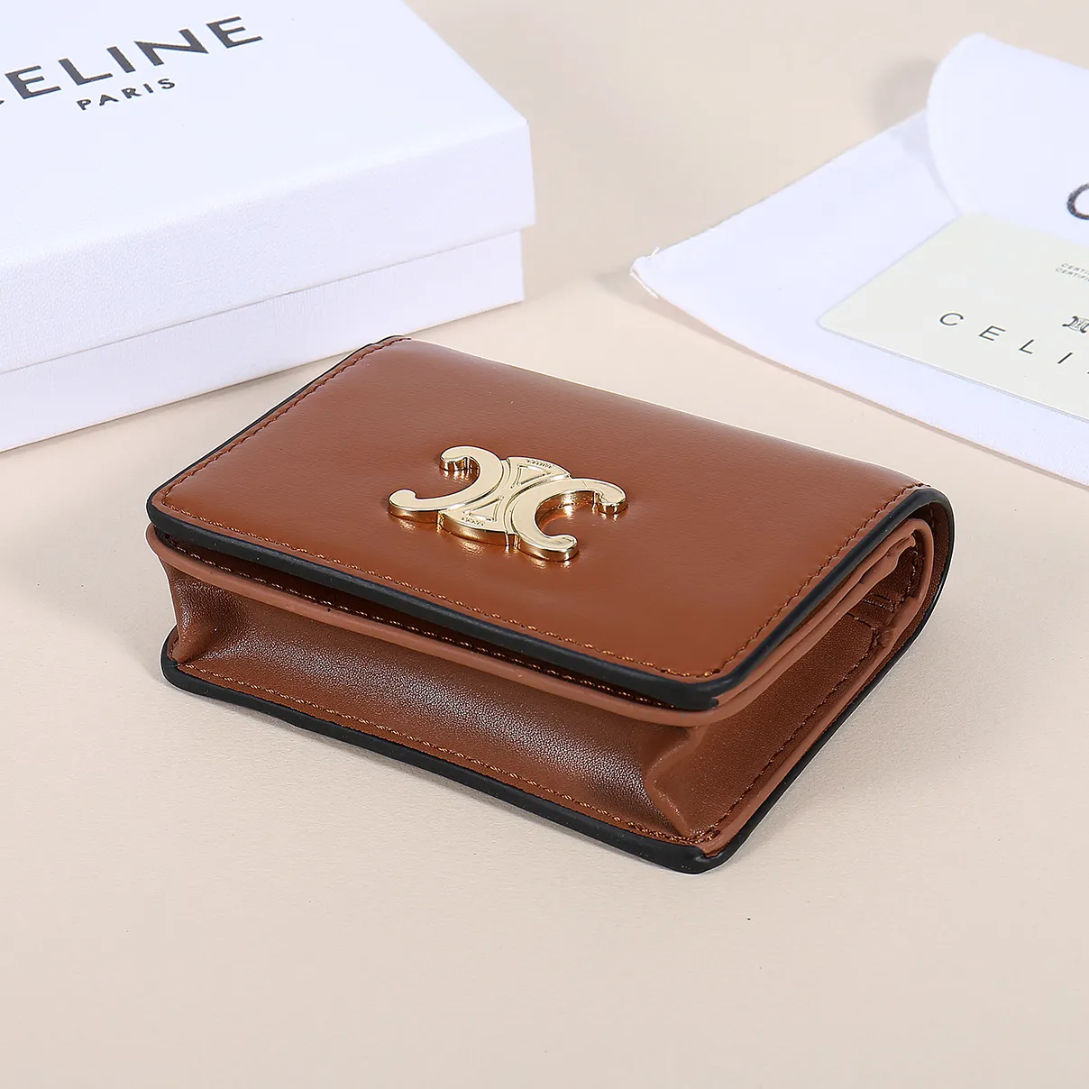 60. Celine classic card holder, TRIOMPHE business card holder, large cowhide interior with plain microfiber TRIOMPHE CANVAS logo print, gold finish TRIOMPHE metal snap closure, 1 zipper coin pocket, 5 card slots, 1 banknote pocket, 1 flat pocket No.: 10K623 Size: 11 X 9 X 3 cm