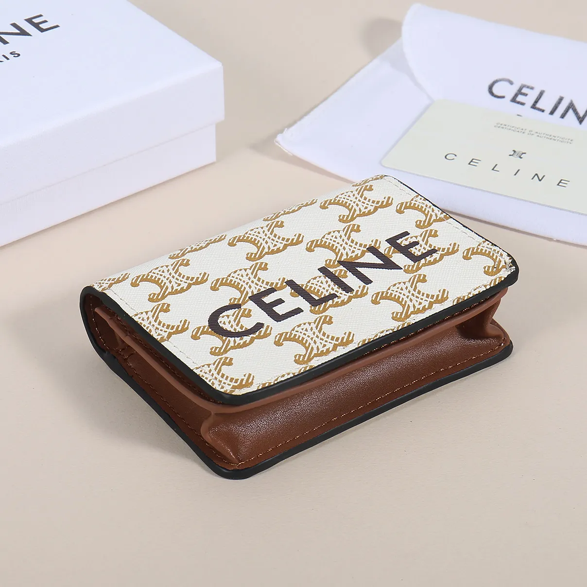 60. Celine classic card holder, TRIOMPHE business card holder, large cowhide interior with plain microfiber TRIOMPHE CANVAS logo print, gold finish TRIOMPHE metal snap closure, 1 zipper coin pocket, 5 card slots, 1 banknote pocket, 1 flat pocket No.: 10K623 Size: 11 X 9 X 3 cm