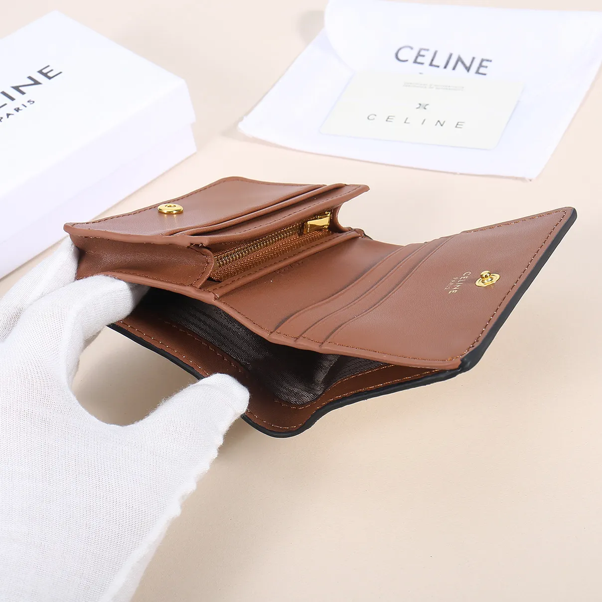 60. Celine classic card holder, TRIOMPHE business card holder, large cowhide interior with plain microfiber TRIOMPHE CANVAS logo print, gold finish TRIOMPHE metal snap closure, 1 zipper coin pocket, 5 card slots, 1 banknote pocket, 1 flat pocket No.: 10K623 Size: 11 X 9 X 3 cm