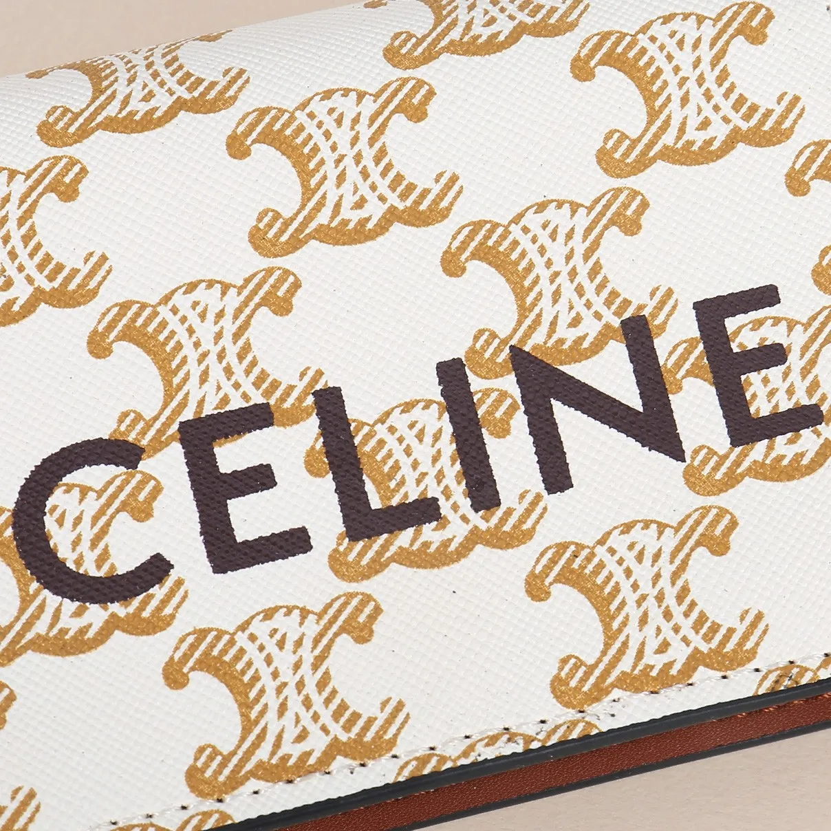 60. Celine classic card holder, TRIOMPHE business card holder, large cowhide interior with plain microfiber TRIOMPHE CANVAS logo print, gold finish TRIOMPHE metal snap closure, 1 zipper coin pocket, 5 card slots, 1 banknote pocket, 1 flat pocket No.: 10K623 Size: 11 X 9 X 3 cm