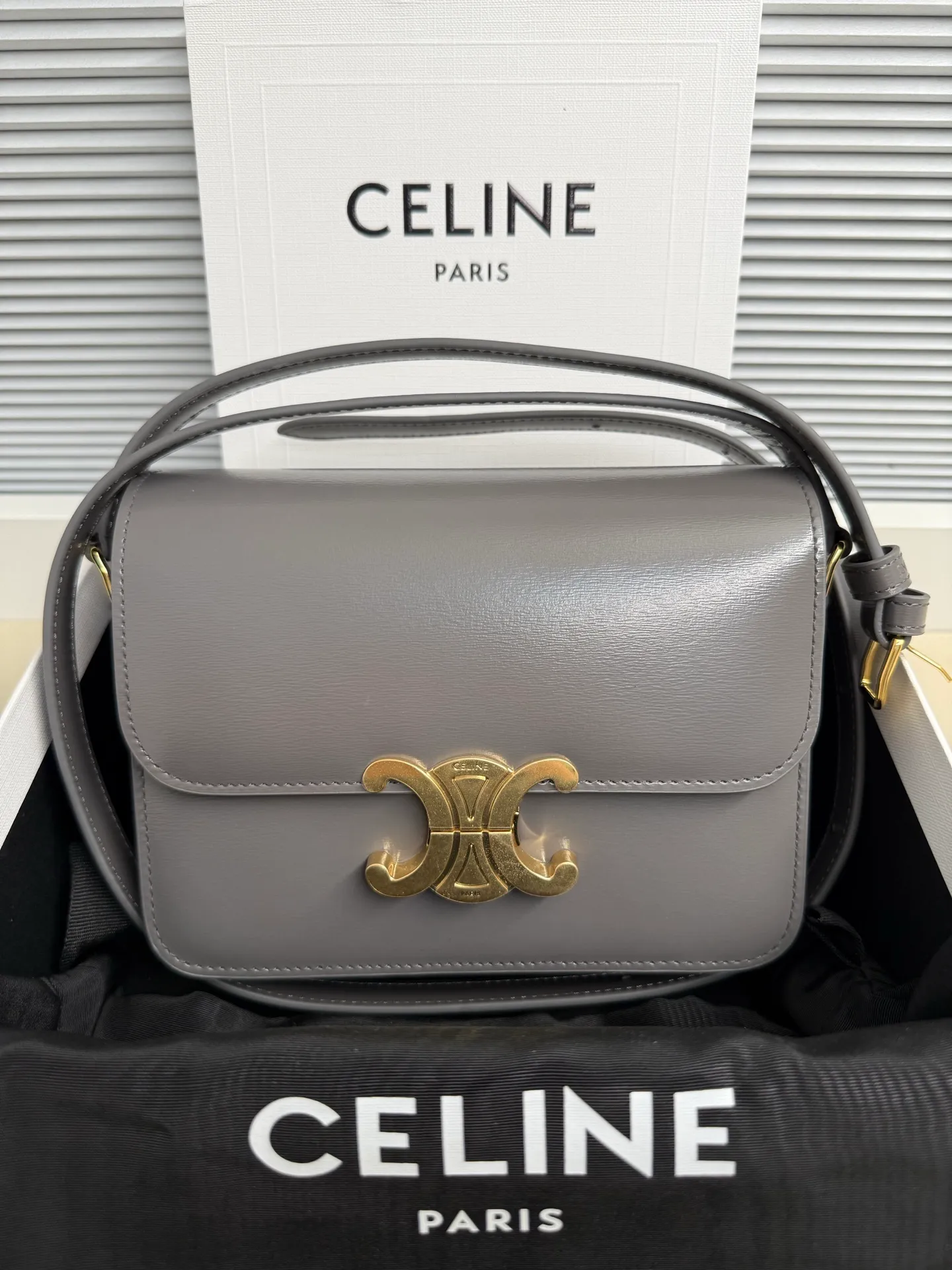 p1560. TEEN TRIOMPHE calfskin handbag This small TRIOMPHE handbag in satin calfskin comes with an adjustable leather shoulder strap and TRIOMPHE exclusive buckle TRIOMPHE brass lock interior zip pocket and interior flat pocket Adjustable leather shoulder strap Length 17 inches (42 cm) 7 X 6 X 2 inches (18.5 X 14 X 6 cm) No.: 188423