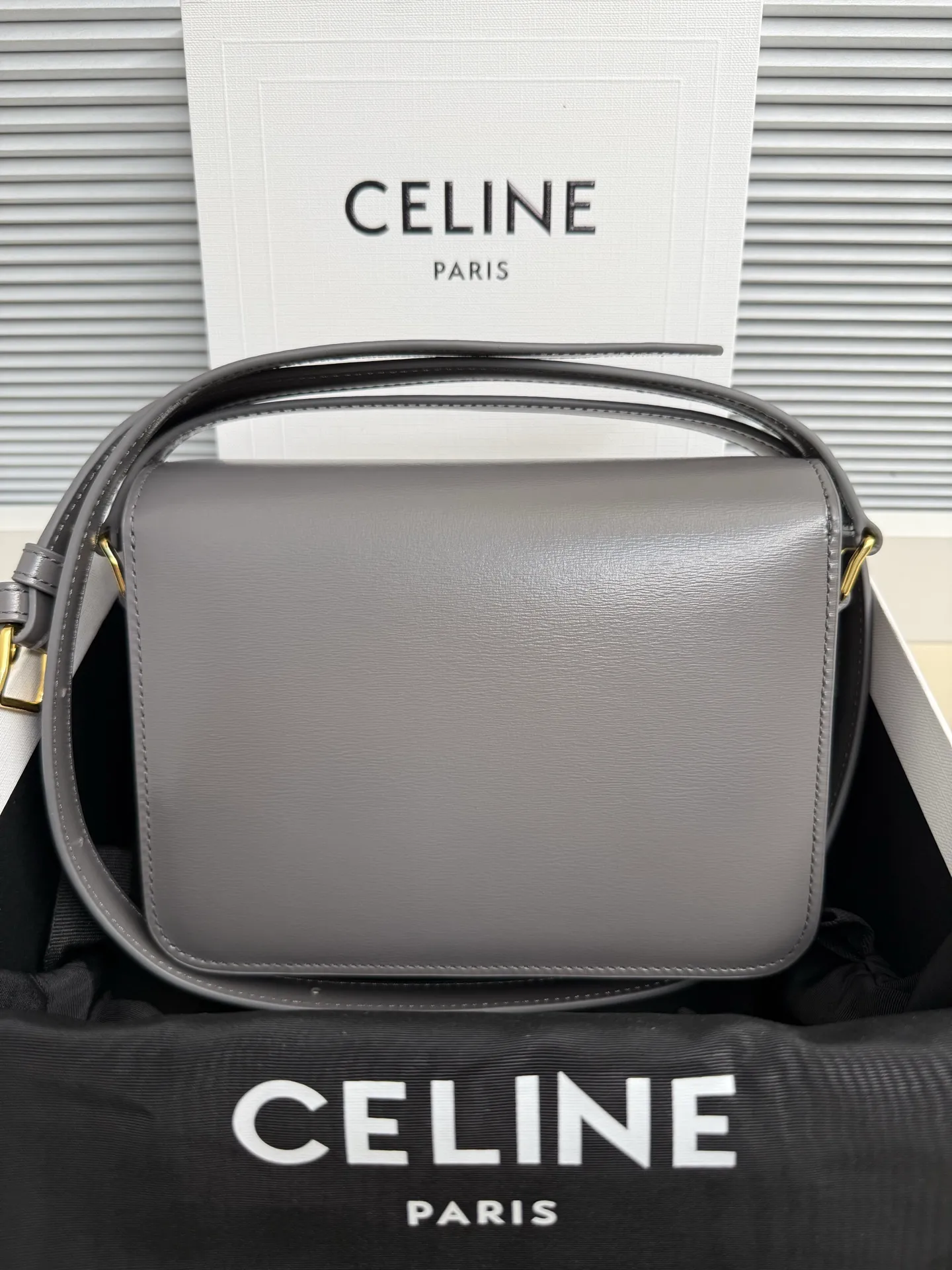 p1560. TEEN TRIOMPHE calfskin handbag This small TRIOMPHE handbag in satin calfskin comes with an adjustable leather shoulder strap and TRIOMPHE exclusive buckle TRIOMPHE brass lock interior zip pocket and interior flat pocket Adjustable leather shoulder strap Length 17 inches (42 cm) 7 X 6 X 2 inches (18.5 X 14 X 6 cm) No.: 188423