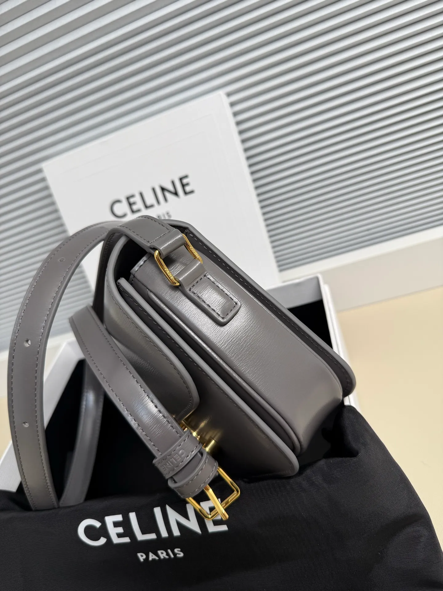 p1560. TEEN TRIOMPHE calfskin handbag This small TRIOMPHE handbag in satin calfskin comes with an adjustable leather shoulder strap and TRIOMPHE exclusive buckle TRIOMPHE brass lock interior zip pocket and interior flat pocket Adjustable leather shoulder strap Length 17 inches (42 cm) 7 X 6 X 2 inches (18.5 X 14 X 6 cm) No.: 188423