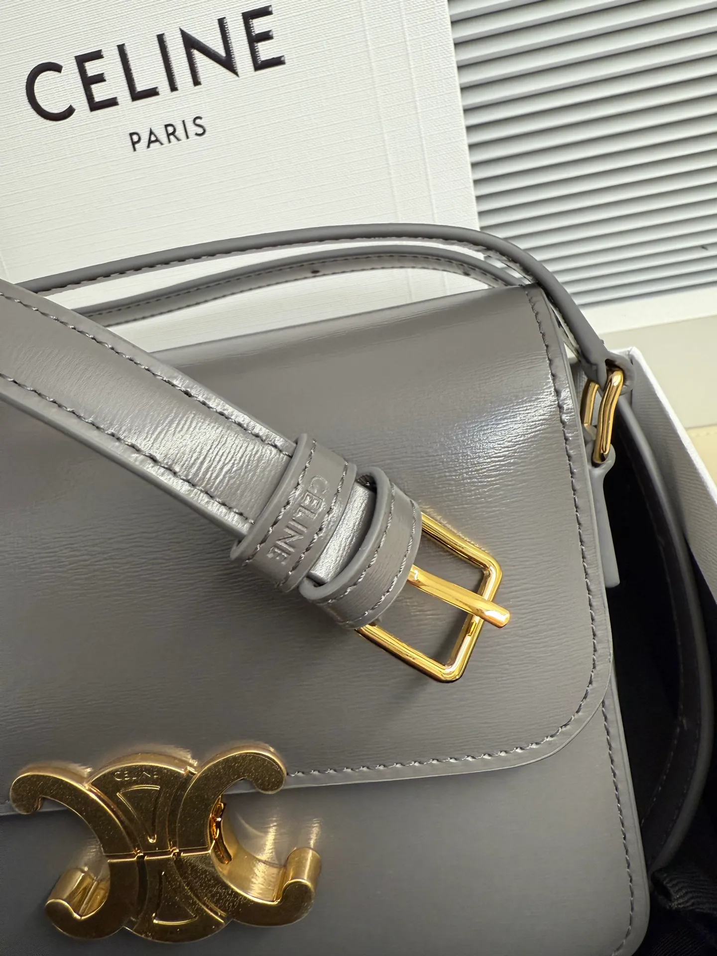 p1560. TEEN TRIOMPHE calfskin handbag This small TRIOMPHE handbag in satin calfskin comes with an adjustable leather shoulder strap and TRIOMPHE exclusive buckle TRIOMPHE brass lock interior zip pocket and interior flat pocket Adjustable leather shoulder strap Length 17 inches (42 cm) 7 X 6 X 2 inches (18.5 X 14 X 6 cm) No.: 188423