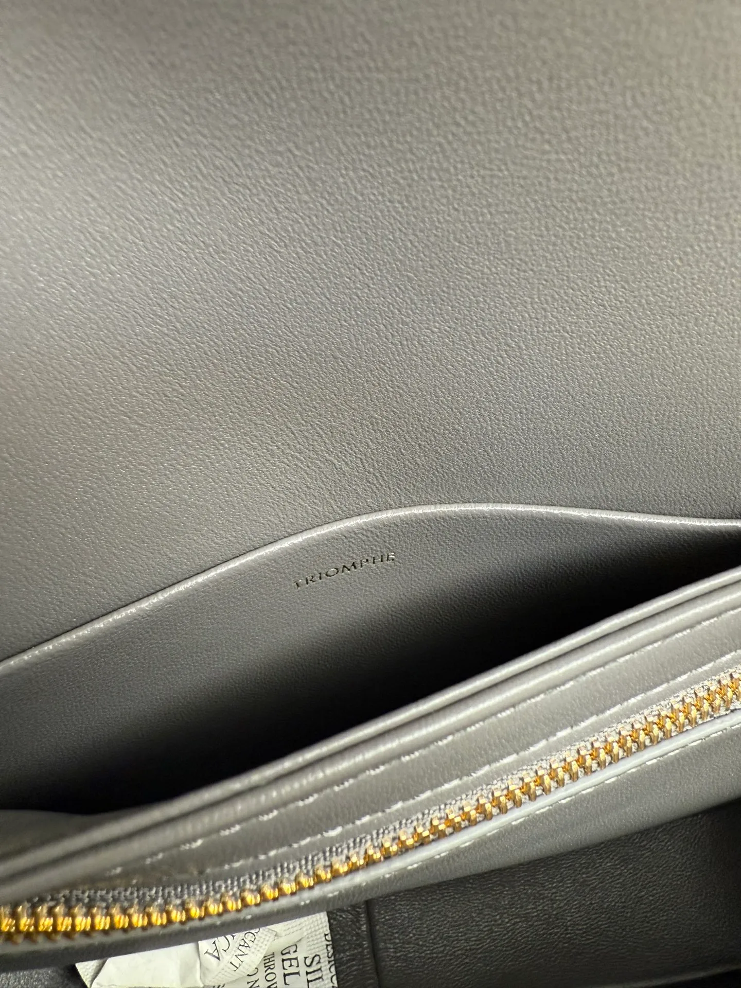 p1560. TEEN TRIOMPHE calfskin handbag This small TRIOMPHE handbag in satin calfskin comes with an adjustable leather shoulder strap and TRIOMPHE exclusive buckle TRIOMPHE brass lock interior zip pocket and interior flat pocket Adjustable leather shoulder strap Length 17 inches (42 cm) 7 X 6 X 2 inches (18.5 X 14 X 6 cm) No.: 188423
