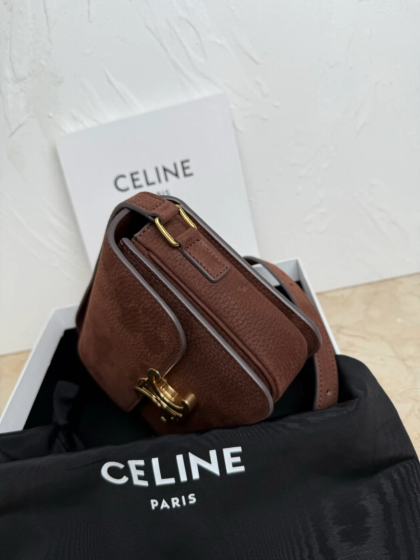 p1560. TEEN TRIOMPHE calfskin handbag This small TRIOMPHE handbag in satin calfskin comes with an adjustable leather shoulder strap and TRIOMPHE exclusive buckle TRIOMPHE brass lock interior zip pocket and interior flat pocket Adjustable leather shoulder strap Length 17 inches (42 cm) 7 X 6 X 2 inches (18.5 X 14 X 6 cm) No.: 188423