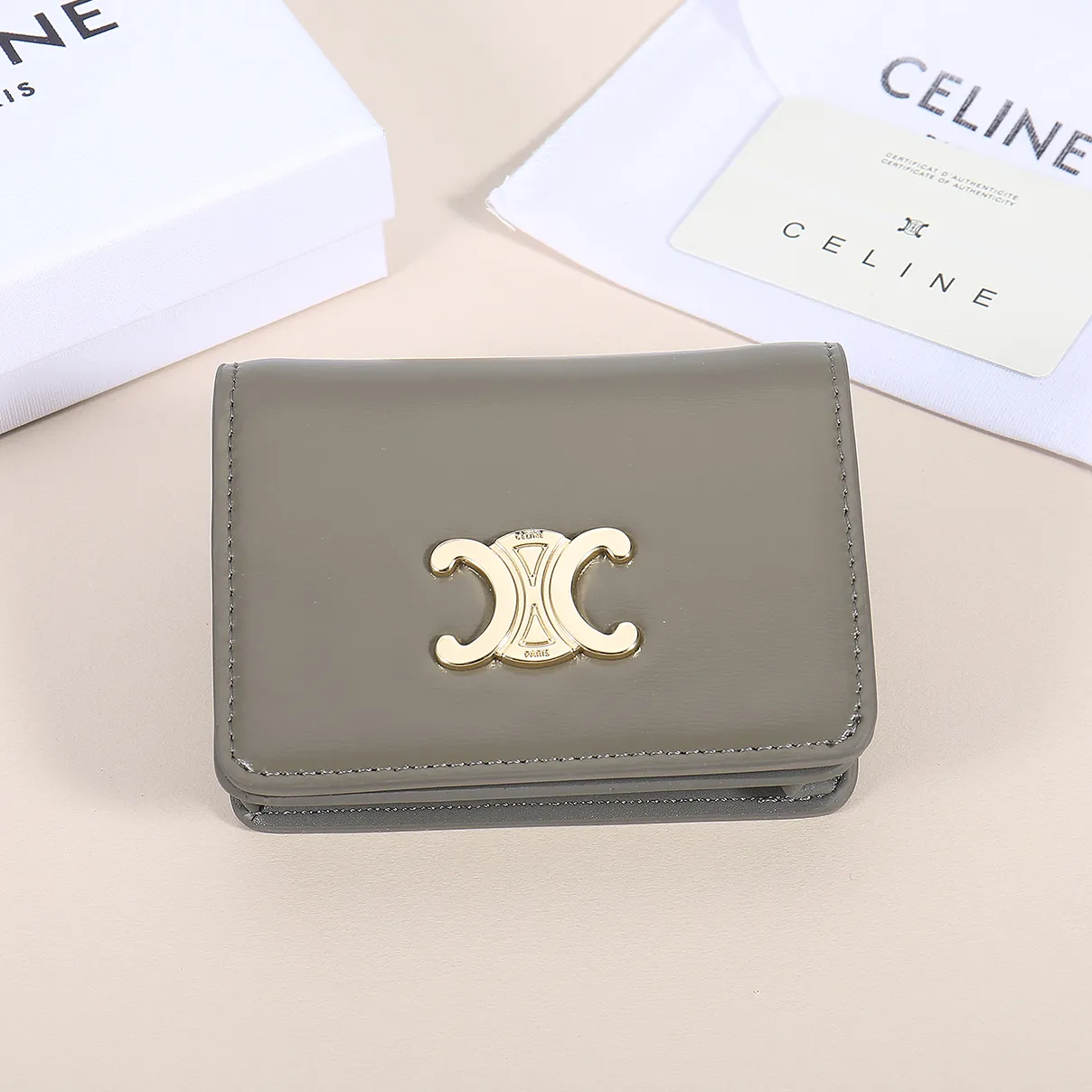 60. Celine classic card holder, TRIOMPHE business card holder, large cowhide interior with plain microfiber TRIOMPHE CANVAS logo print, gold finish TRIOMPHE metal snap closure, 1 zipper coin pocket, 5 card slots, 1 banknote pocket, 1 flat pocket No.: 10K623 Size: 11 X 9 X 3 cm