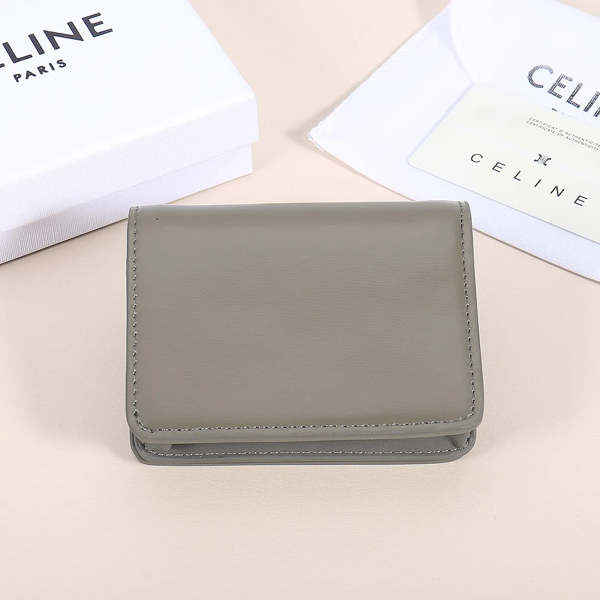 60. Celine classic card holder, TRIOMPHE business card holder, large cowhide interior with plain microfiber TRIOMPHE CANVAS logo print, gold finish TRIOMPHE metal snap closure, 1 zipper coin pocket, 5 card slots, 1 banknote pocket, 1 flat pocket No.: 10K623 Size: 11 X 9 X 3 cm