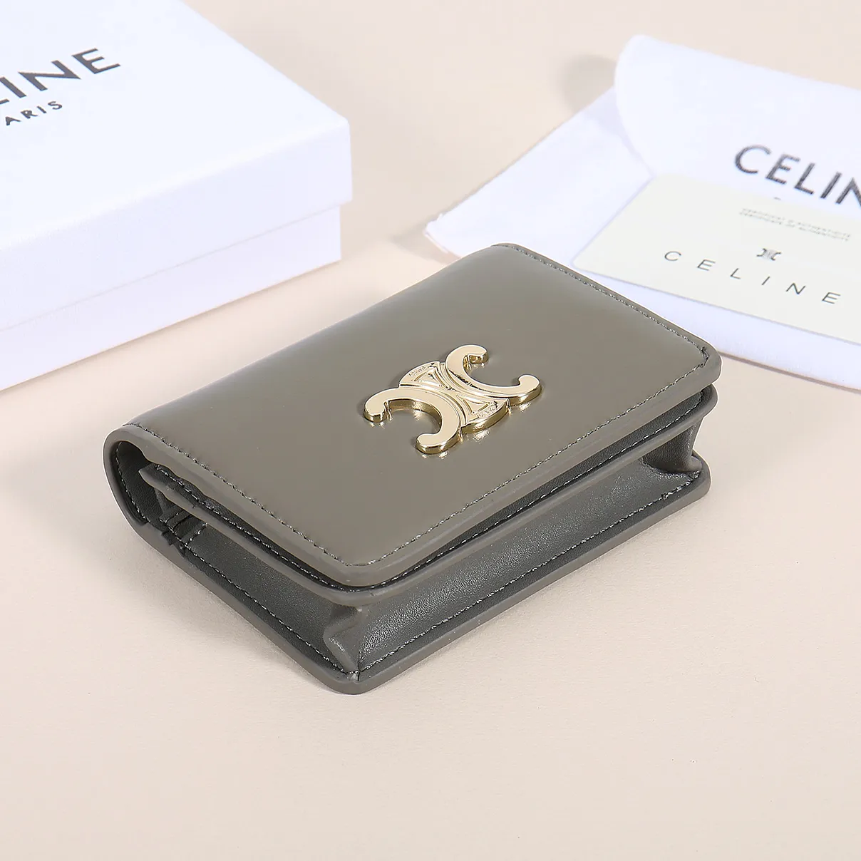 60. Celine classic card holder, TRIOMPHE business card holder, large cowhide interior with plain microfiber TRIOMPHE CANVAS logo print, gold finish TRIOMPHE metal snap closure, 1 zipper coin pocket, 5 card slots, 1 banknote pocket, 1 flat pocket No.: 10K623 Size: 11 X 9 X 3 cm