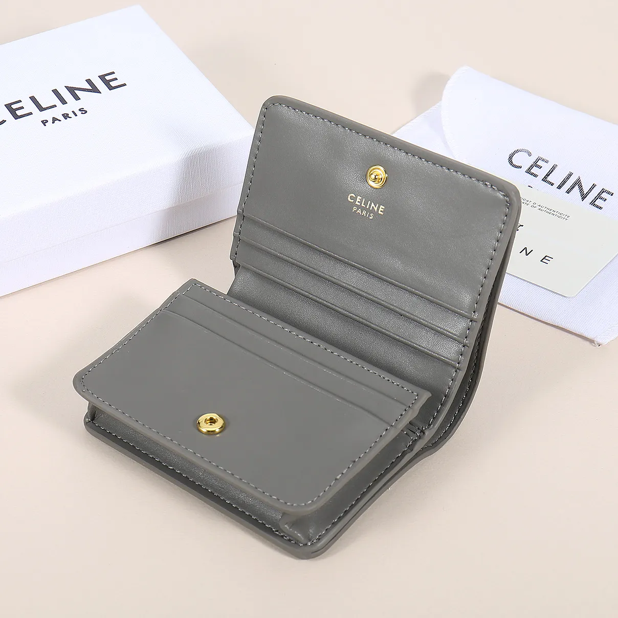 60. Celine classic card holder, TRIOMPHE business card holder, large cowhide interior with plain microfiber TRIOMPHE CANVAS logo print, gold finish TRIOMPHE metal snap closure, 1 zipper coin pocket, 5 card slots, 1 banknote pocket, 1 flat pocket No.: 10K623 Size: 11 X 9 X 3 cm