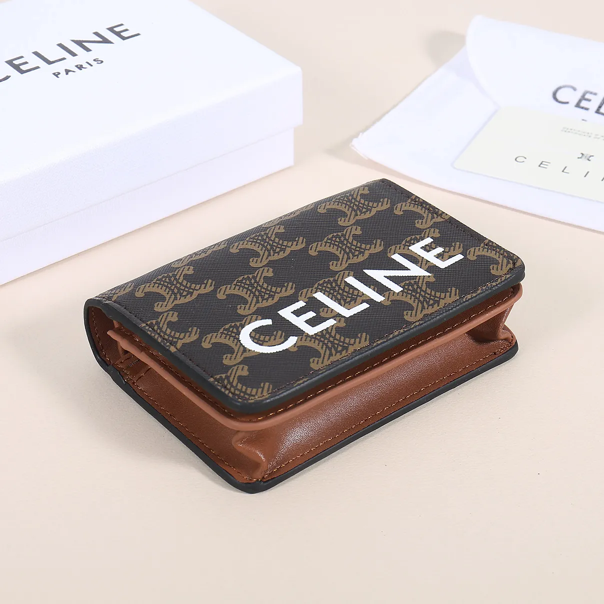 60. Celine classic card holder, TRIOMPHE business card holder, large cowhide interior with plain microfiber TRIOMPHE CANVAS logo print, gold finish TRIOMPHE metal snap closure, 1 zipper coin pocket, 5 card slots, 1 banknote pocket, 1 flat pocket No.: 10K623 Size: 11 X 9 X 3 cm
