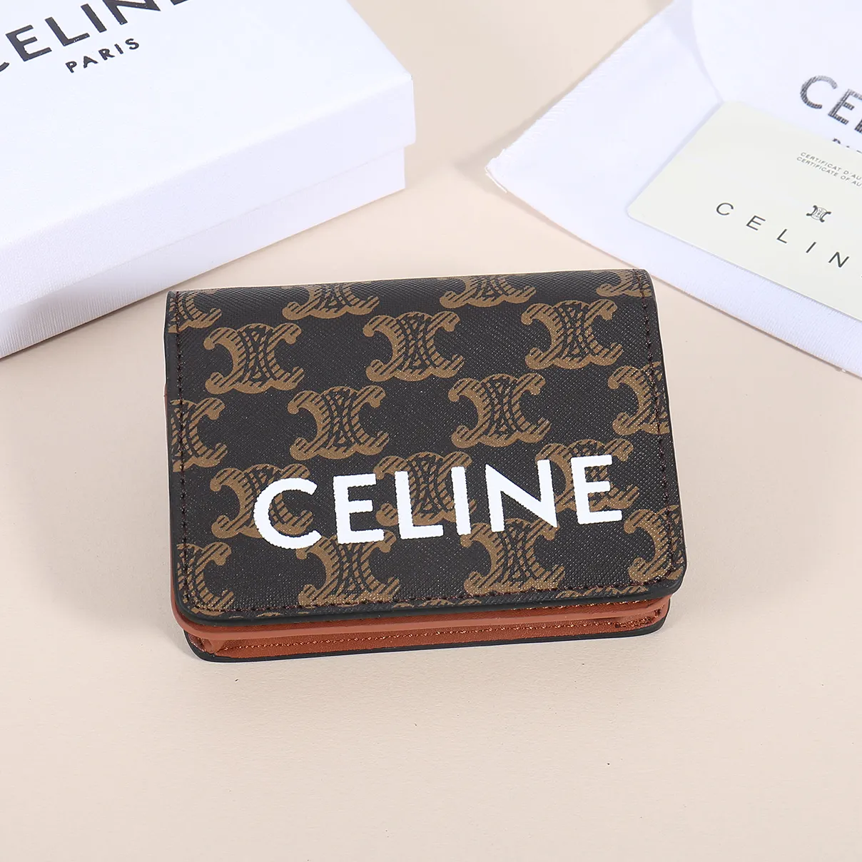 60. Celine classic card holder, TRIOMPHE business card holder, large cowhide interior with plain microfiber TRIOMPHE CANVAS logo print, gold finish TRIOMPHE metal snap closure, 1 zipper coin pocket, 5 card slots, 1 banknote pocket, 1 flat pocket No.: 10K623 Size: 11 X 9 X 3 cm