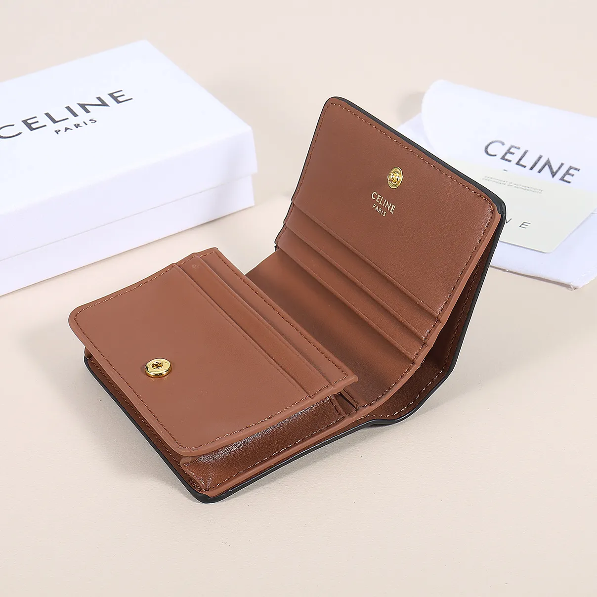 60. Celine classic card holder, TRIOMPHE business card holder, large cowhide interior with plain microfiber TRIOMPHE CANVAS logo print, gold finish TRIOMPHE metal snap closure, 1 zipper coin pocket, 5 card slots, 1 banknote pocket, 1 flat pocket No.: 10K623 Size: 11 X 9 X 3 cm