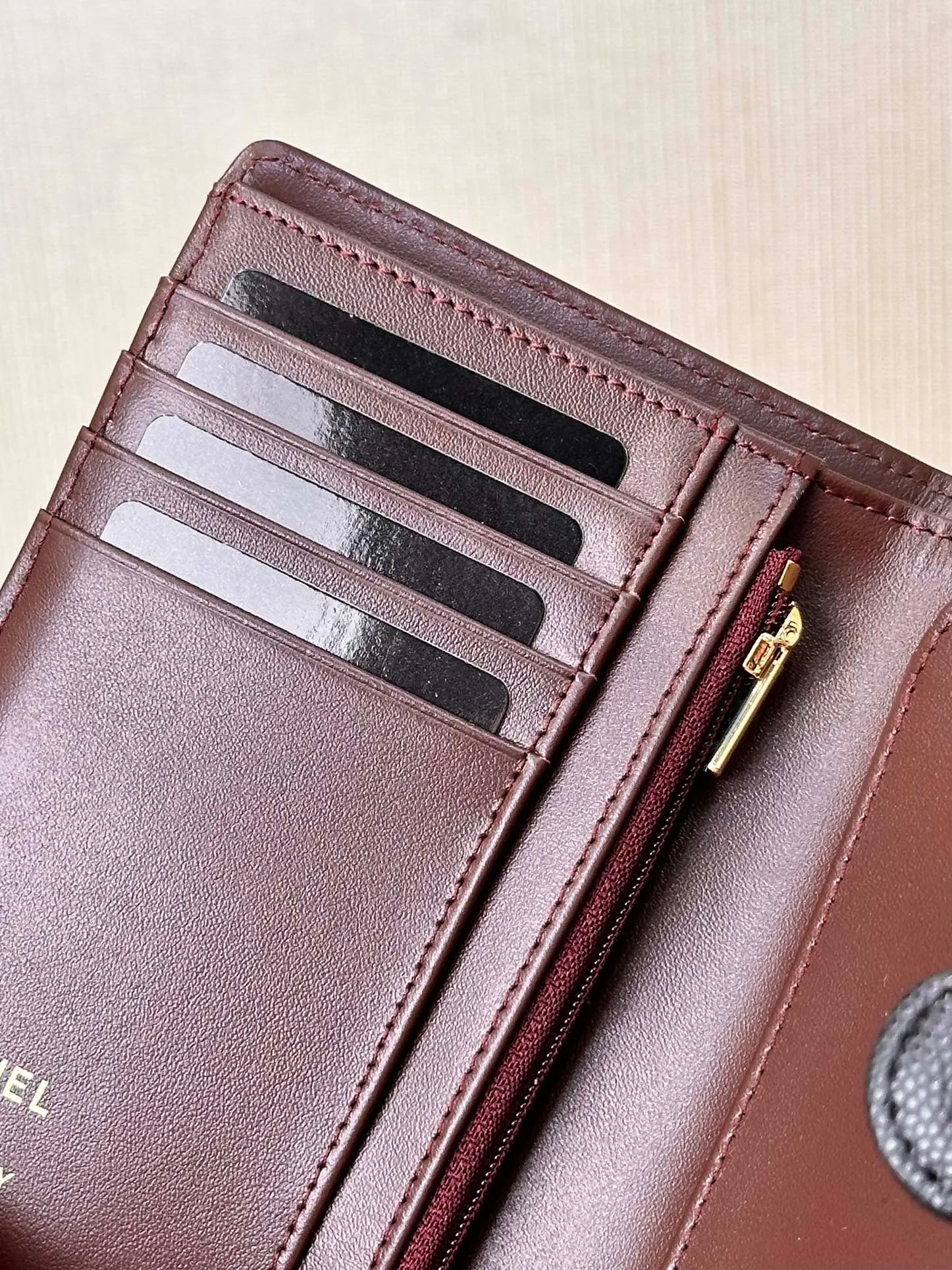 96066 The interior is made of burgundy calfskin. The leather has its own luster, and the texture is clear and delicate. It has various card slots on the side and an anti-counterfeiting code design on the inside.