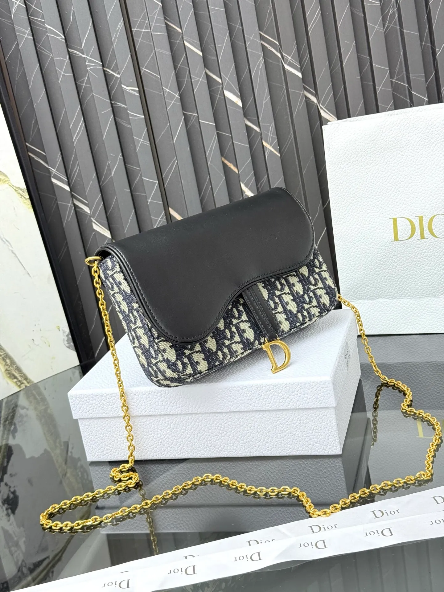 💰290💰 This saddle chain handbag has smooth and coordinated lines, making it a fashionable and practical item. Carefully crafted from blue Denim Dior Oblique jacquard fabric, the classic Dior pattern is reinterpreted with an irregular stonewash effect to highlight the fashionable style. It is paired with an asymmetric flap and a metal stirrup D-shaped pendant with antique gold finish. The spacious interior compartments can store a variety of daily essentials, and the chain makes it easy to carry on the shoulder or cross-body. Easily combines with other pieces from the saddle collection. Flap closure No.: S5907CTZQ_M928 Front stirrup D-shaped charm 1 compartment 6 card slots 1 slip pocket - No.: S5097 Dimensions: 21.5x12.5x3.7 cm (LxHxW) Can store 1 mobile phone, 1 card holder and lipstick Chain length: 118 cm Length from the top of the chain to the top of the bag: 57 cm