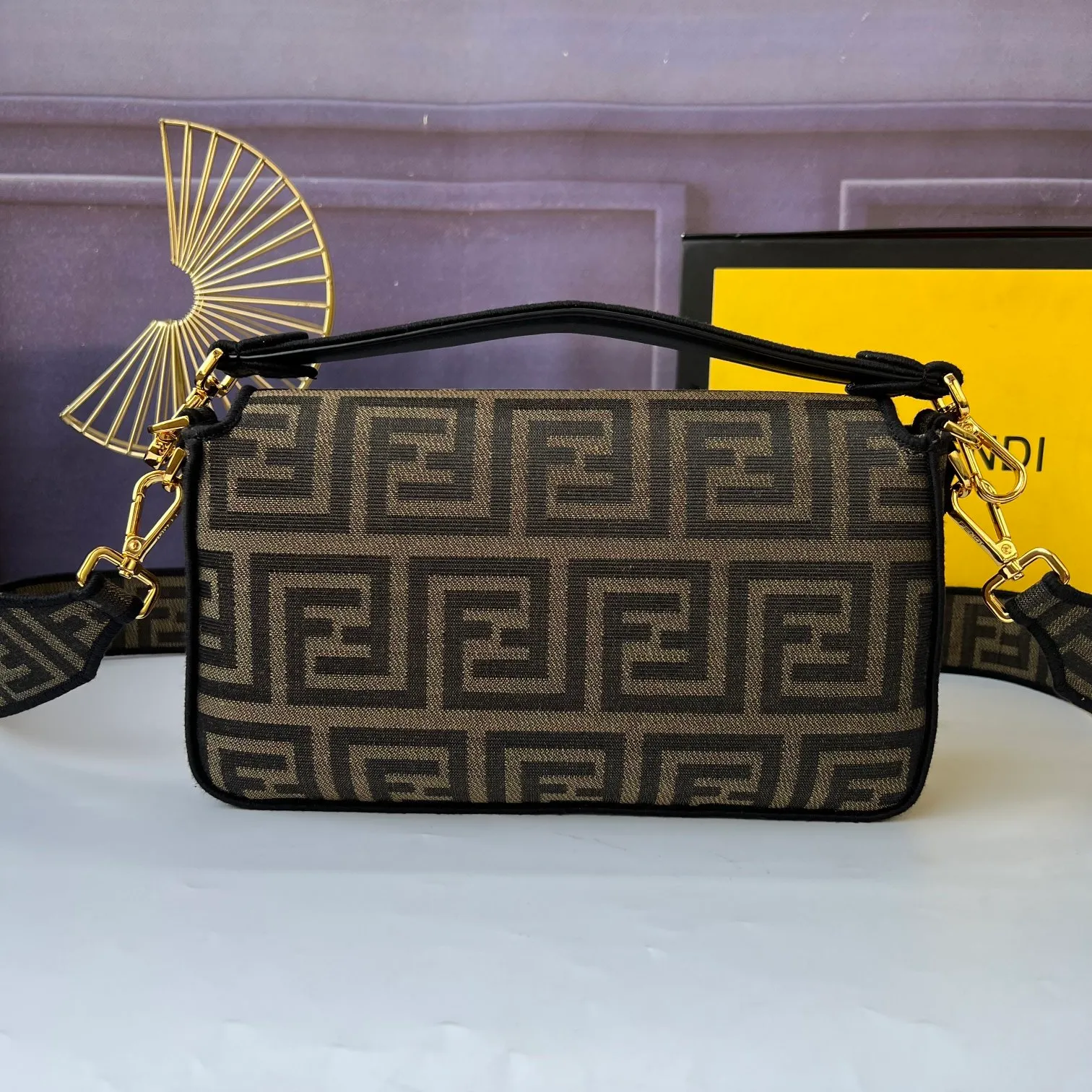 All Categories Official Website "Brand Women's Bags" Women's Bags 💙 FENDI The latest FendiVersace co-branded model, the iconic Baguette medium handbag adopts a clamshell design and is equipped with FF magnetic buckle closure. Lined interior with zip pocket. Comes with a detachable handle or shoulder strap for cross-body or hand carry. Decorated with tonal FF logo embroidery. Contrasting brown leather trim