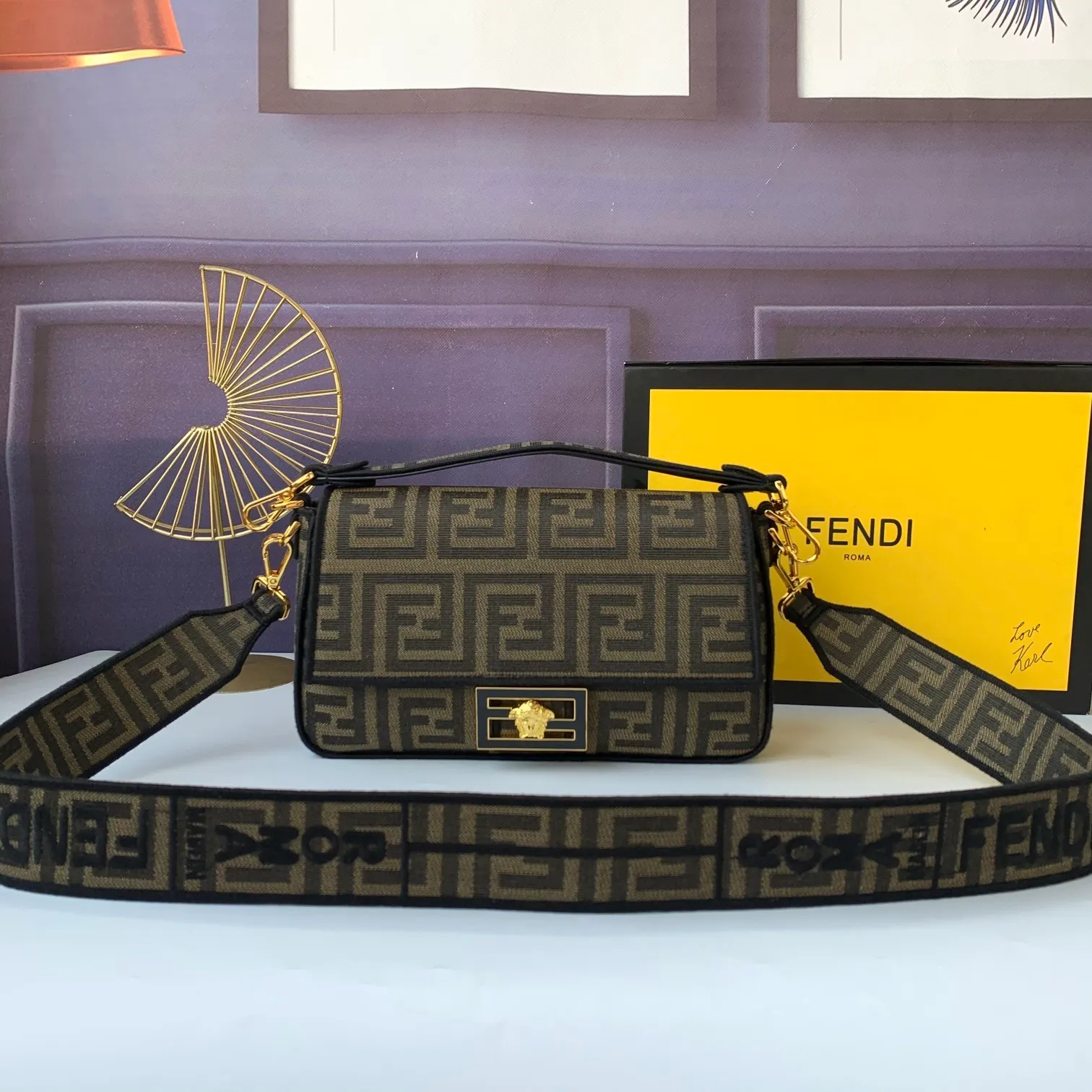 All Categories Official Website "Brand Women's Bags" Women's Bags 💙 FENDI The latest FendiVersace co-branded model, the iconic Baguette medium handbag adopts a clamshell design and is equipped with FF magnetic buckle closure. Lined interior with zip pocket. Comes with a detachable handle or shoulder strap for cross-body or hand carry. Decorated with tonal FF logo embroidery. Contrasting brown leather trim