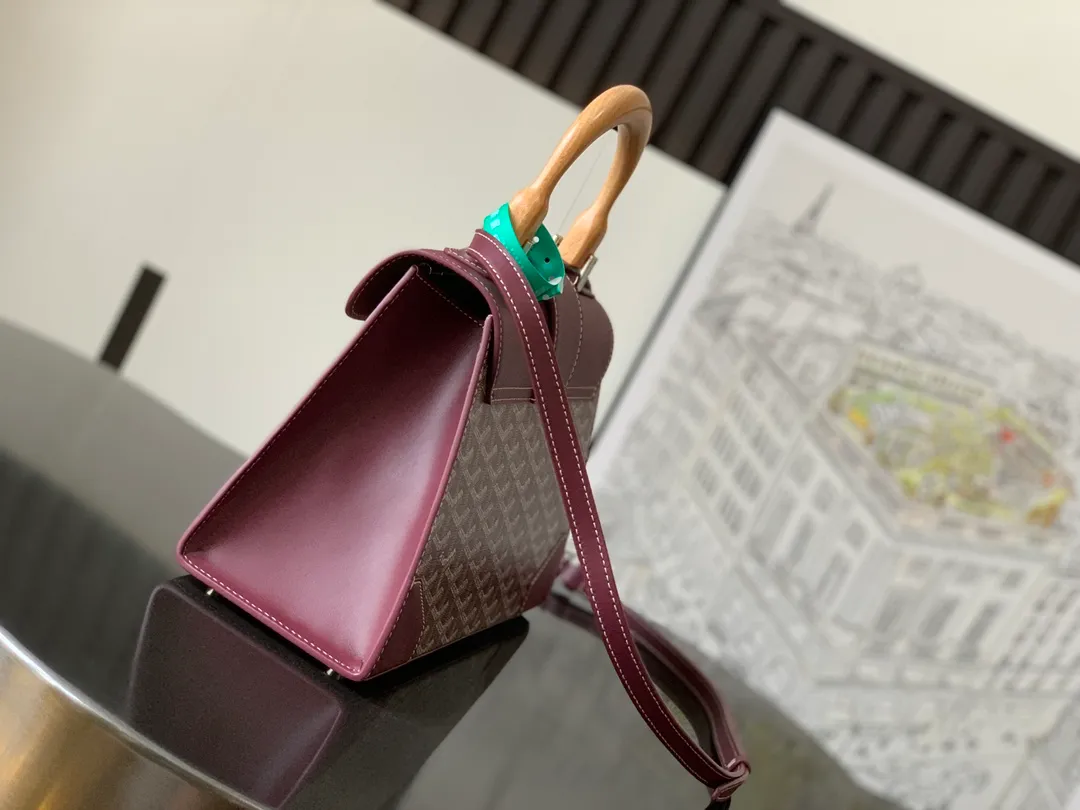 P1700 original.  The Saïgon bag is one of the iconic pieces of the House of Goyard, embodying all the characteristic elements of the brand's boxmaking craftsmanship, such as wood, strips, leather corners and tacks. The Saigon Small Bag features a structured design and a removable shoulder strap for a chic and elegant look.  20 cm x 12 cm x 28 cm 🔎LAR 020186-maroon