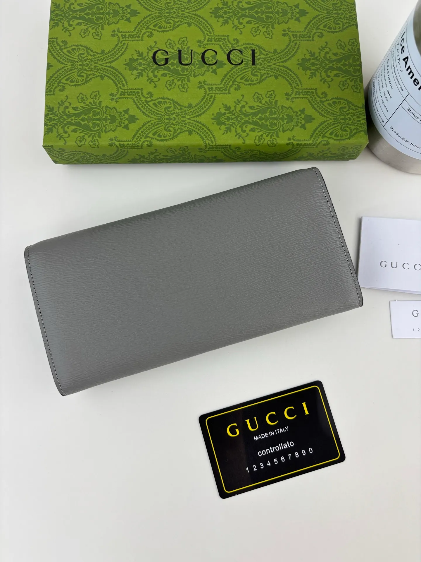 💰170 GUCCl long clip wallet with handwritten Gucci logo. Exploring self-expression with unlimited possibilities has become the spiritual connotation of brand design. Crafted from gray leather, this long clip is embellished with a gold-toned handwritten Gucci logo-shaped hardware, adding a touch of the brand's signature charm to the entire design. Gray leather, gold-tone hardware, taffeta lining, script Gucci logo detail. INTERIOR: Twelve card compartments, two bill compartments, two separate internal compartments and a zipped coin pocket, this classic piece features snap closure Style number: 772638 Dimensions: 19cm x 10cm x 3.5cm Colour: Gray