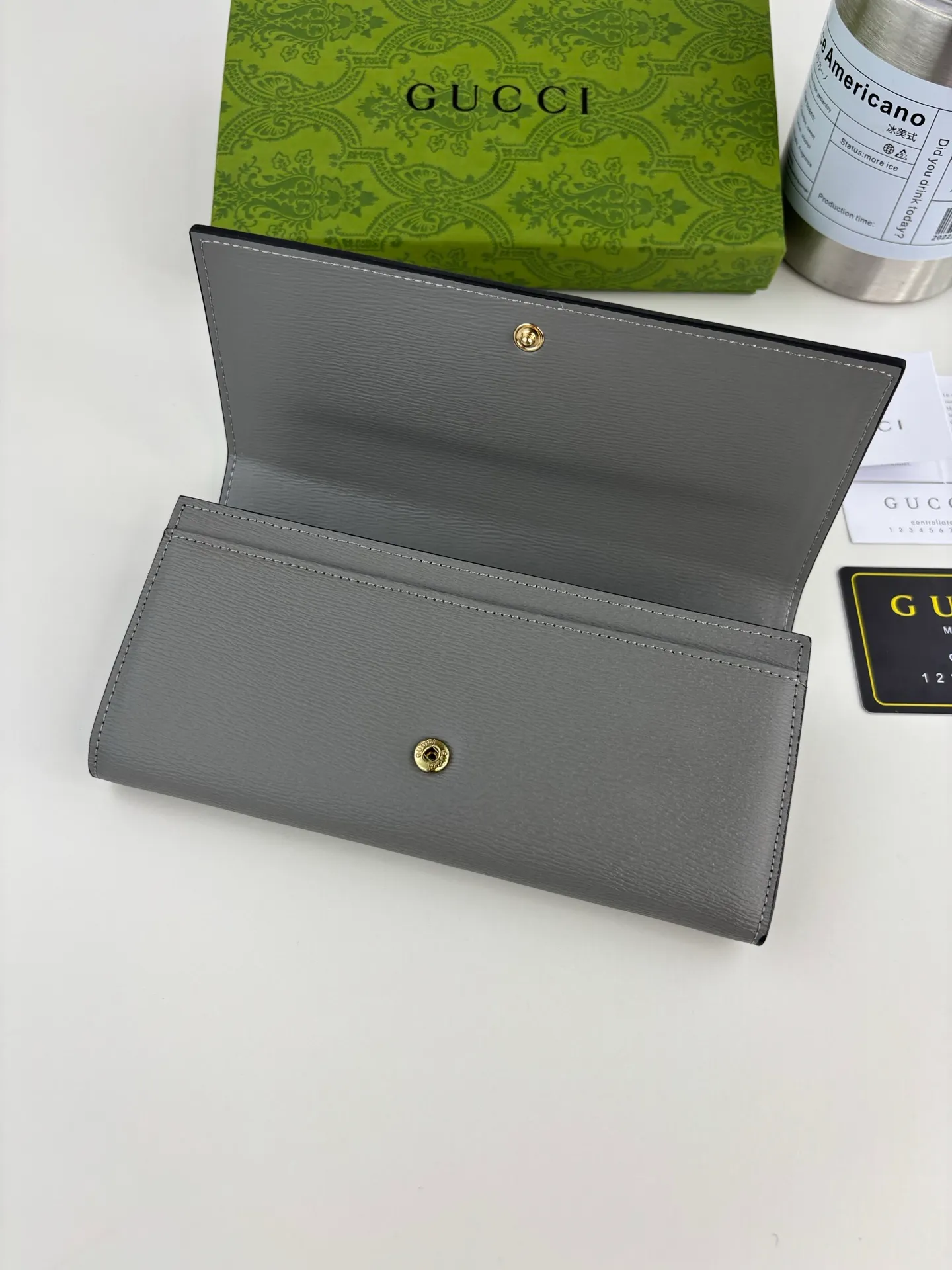 💰170 GUCCl long clip wallet with handwritten Gucci logo. Exploring self-expression with unlimited possibilities has become the spiritual connotation of brand design. Crafted from gray leather, this long clip is embellished with a gold-toned handwritten Gucci logo-shaped hardware, adding a touch of the brand's signature charm to the entire design. Gray leather, gold-tone hardware, taffeta lining, script Gucci logo detail. INTERIOR: Twelve card compartments, two bill compartments, two separate internal compartments and a zipped coin pocket, this classic piece features snap closure Style number: 772638 Dimensions: 19cm x 10cm x 3.5cm Colour: Gray