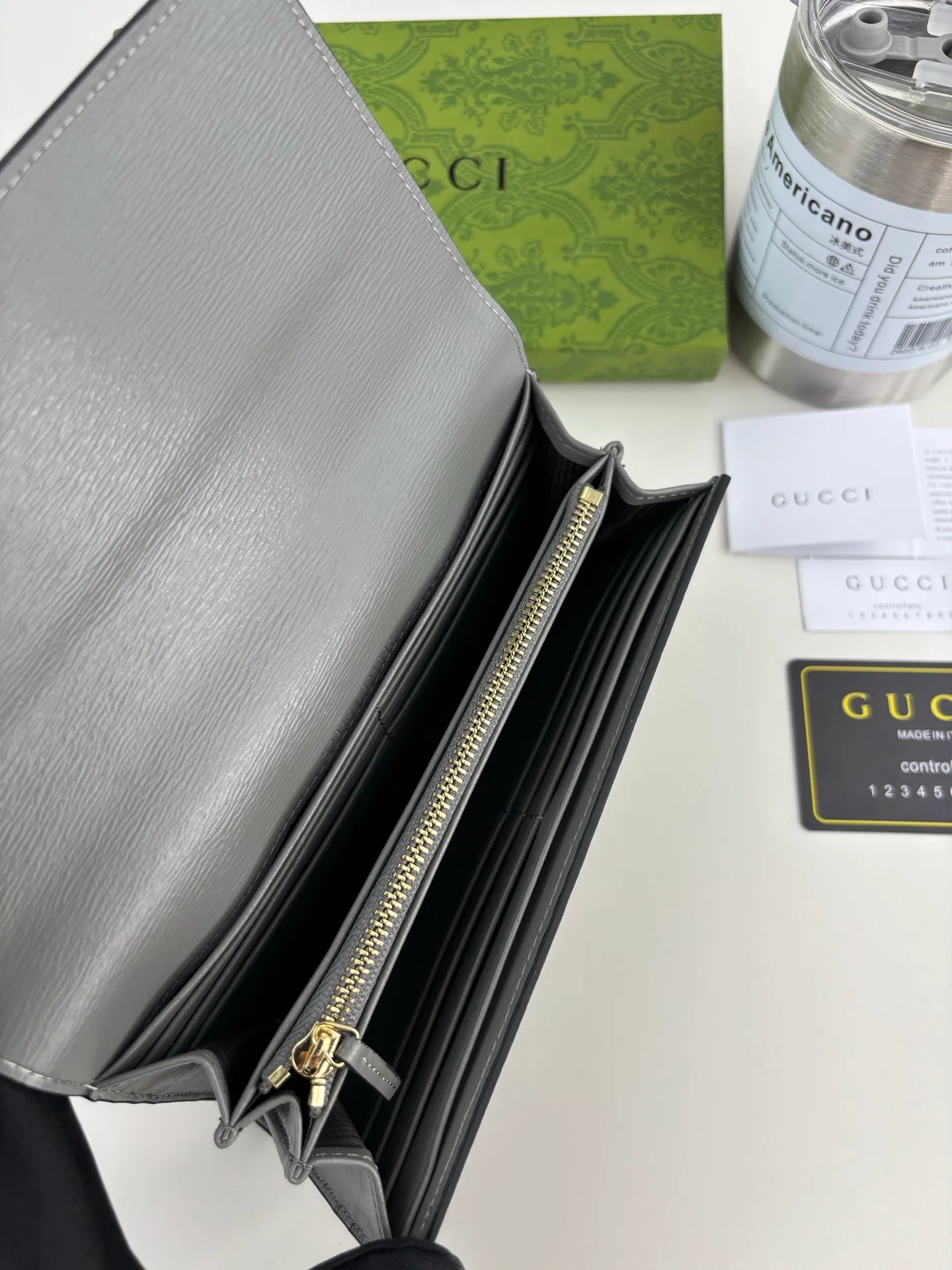 💰170 GUCCl long clip wallet with handwritten Gucci logo. Exploring self-expression with unlimited possibilities has become the spiritual connotation of brand design. Crafted from gray leather, this long clip is embellished with a gold-toned handwritten Gucci logo-shaped hardware, adding a touch of the brand's signature charm to the entire design. Gray leather, gold-tone hardware, taffeta lining, script Gucci logo detail. INTERIOR: Twelve card compartments, two bill compartments, two separate internal compartments and a zipped coin pocket, this classic piece features snap closure Style number: 772638 Dimensions: 19cm x 10cm x 3.5cm Colour: Gray
