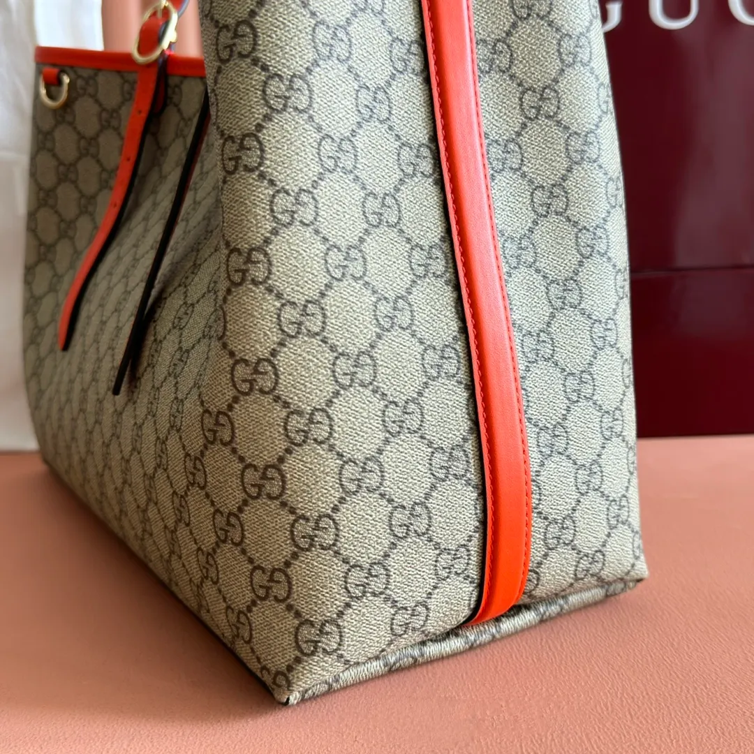 p980. 💋💋💋"With full set of original counter packaging" [New product] GG Emblem series reinterprets the brand's timeless elegance and exquisite craftsmanship. Inspired by the equestrian world, this tote bag features an adjustable top handle with numbered eyelets. New GG monogram coated fabric in beige and dark brown Orange leather trim with contrast stitching Light gold tone hardware Red and green webbing cotton lining The bag pictured is sold separately and does not come with the bag charm. Also features D-ring for hanging removable items Adjustable handle with numbered eyelets (height: 21.5 cm - 31.5 cm) Interior: two compartments and one central zipped compartment Magnetic snap closure Ident.: 815213. Dimensions: 38cm (width) x 25cm (height) x 15cm (depth) Weight: about 0.85kg Color: brown orange PVC/original leather. Made in Italy