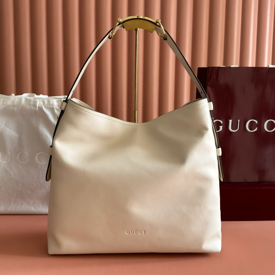 p1760💋💋💋【With full set of original counter gift bag packaging】2025 autumn and winter series, Gucci Beatrix series handbags are crafted from black cow leather material and equipped with iconic horsebit detail shoulder straps, adding brand connotation to the casual silhouette. Gold-toned accessories add a refined touch, and a zippered pocket inside keeps daily essentials secure. Combining elegant design with practical performance, it easily accommodates daily essentials. Black soft glossy calf leather Gold-tone hardware Black cotton and linen blend lining Horsebit detail on shoulder strap Interior: Zip pocket Adjustable shoulder strap Height: 26cm - 33cm; Length: 94cm Ident: 850546. Dimensions: 40cm (width) x 36cm (height) x 12cm (depth) Weight: approx. 1kg Color: White full leather. Made in Italy