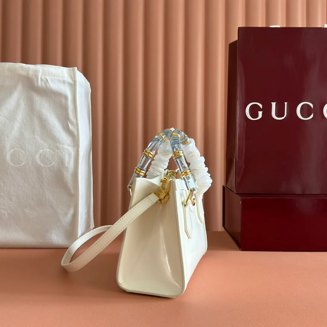 p1560. 💋💋💋【With full set of original counter packaging】【New Product】In the 2025 spring and summer series, the Gucci Diana series reinterprets classic bamboo accessories with resin and brass details. There are many ways to carry it, it can be carried cross-body or on the shoulder. Light purple glossy polished sheepskin Gold-tone hardware Bamboo shaped resin and brass handles Light purple sheepskin lining Double G Interior: One open pocket 8 cm high Removable and adjustable sheepskin shoulder strap (48 to 55 cm high); length adjustable from 93 to 109 cm Ident.: 832936. Dimensions: 20cm (width) x 16cm (height) x 10cm (depth) Weight: approx. 0.95kg Color: White full leather. Made in Italy