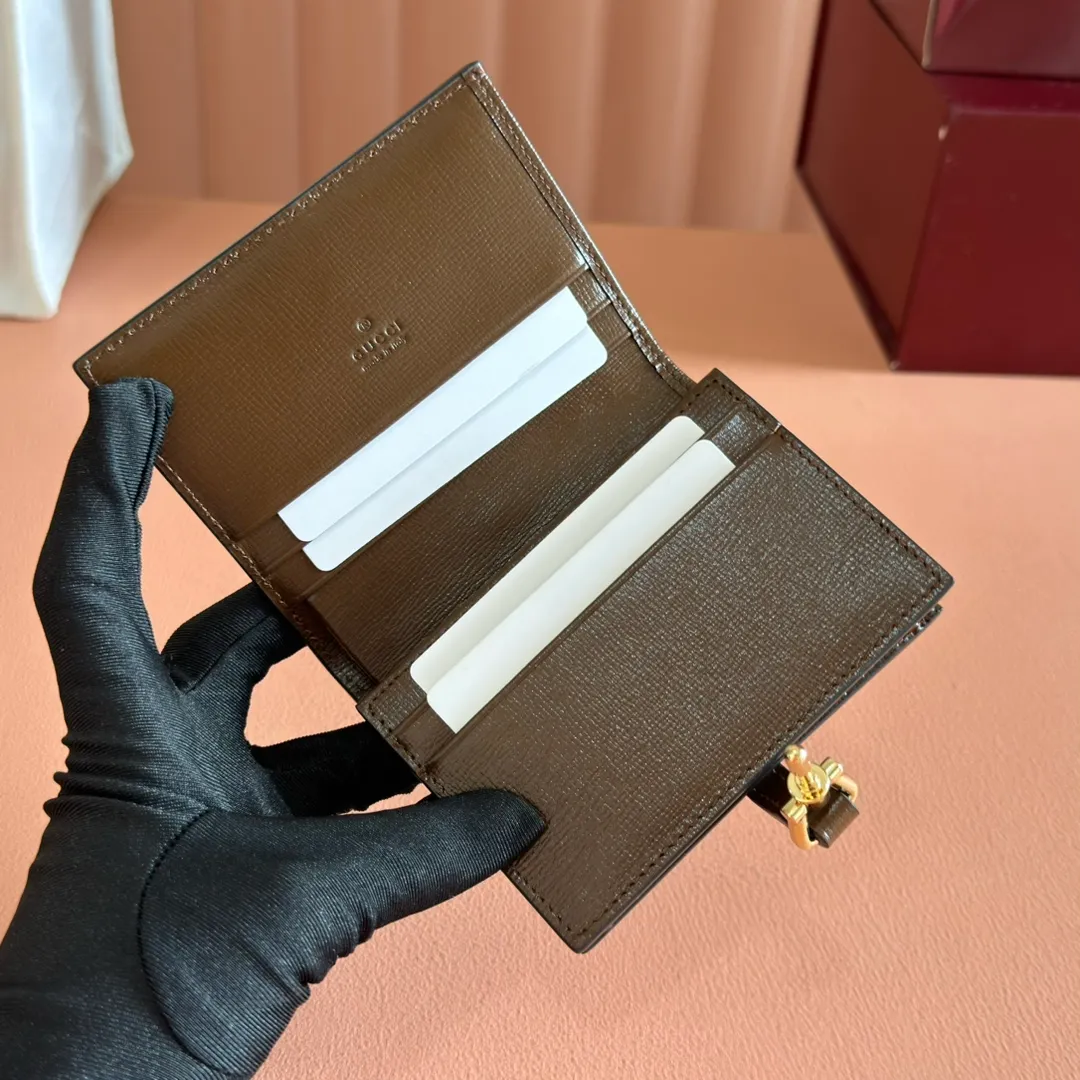 p460. 💋💋💋 [Original leather accessories 🌈 Equipped with full counter packaging] 🔥🔥 The jackie1961 series launches a compact and noble new card holder shape. Gold-toned push-lock closure, washed denim give the entire design a timeless and elegant feel, five card compartments, two flat pockets, one zip pocket, and interior open pocket. Dimensions: 11×8.5x3. Model: 645536.