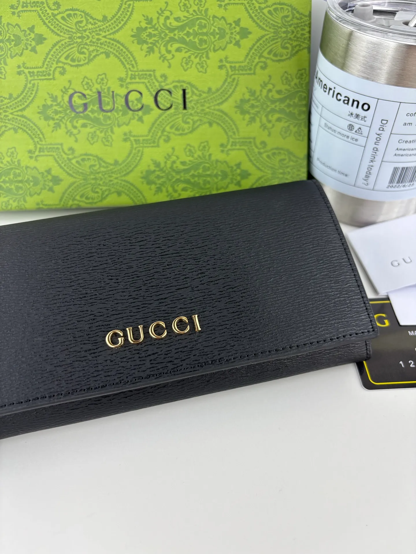 💰170 GUCCl long clip wallet with handwritten Gucci logo. Exploring self-expression with unlimited possibilities has become the spiritual connotation of brand design. Crafted from black leather, this long clip is embellished with a gold-toned handwritten Gucci logo-shaped hardware, adding a touch of the brand's signature charm to the entire design. Black leather, gold-tone hardware, taffeta lining, script Gucci logo detail. Interior: Twelve card compartments, two bill compartments, two separate internal compartments and a zippered coin pocket, this classic piece features snap fastening Style number: 772638 Dimensions: 19cm x 10cm x 3.5cm Colour: Black