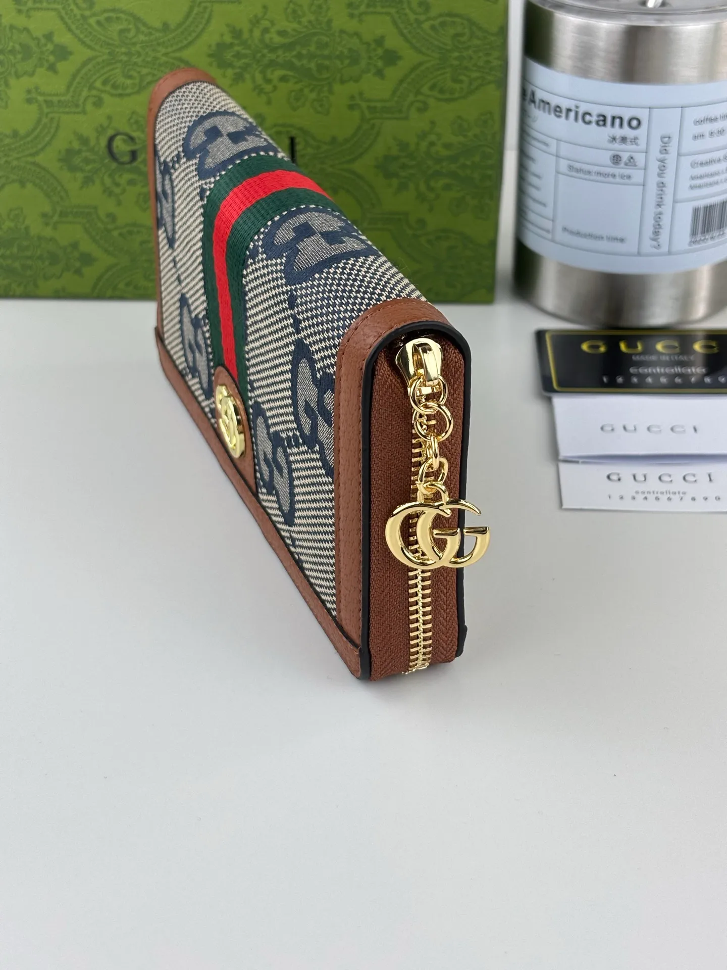 💰170 GUCCl full zipper wallet. The GG logo, which began to be used in the 1970s, evolved from the early Gucci diamond pattern that began in the 1930s. This full-zip wallet combines iconic graphics with striped webbing, a timeless combination that pays homage to Gucci's roots. Brown/ebony GG Supreme canvas with brown leather trim, gold-toned hardware Double G, 12 card compartments, 3 bill compartments, zipped coin pocket, full zip closure. Style number: 523154 Size: 19cm x 10cm x 2.5cm Color: blue small G/brown on cloth
