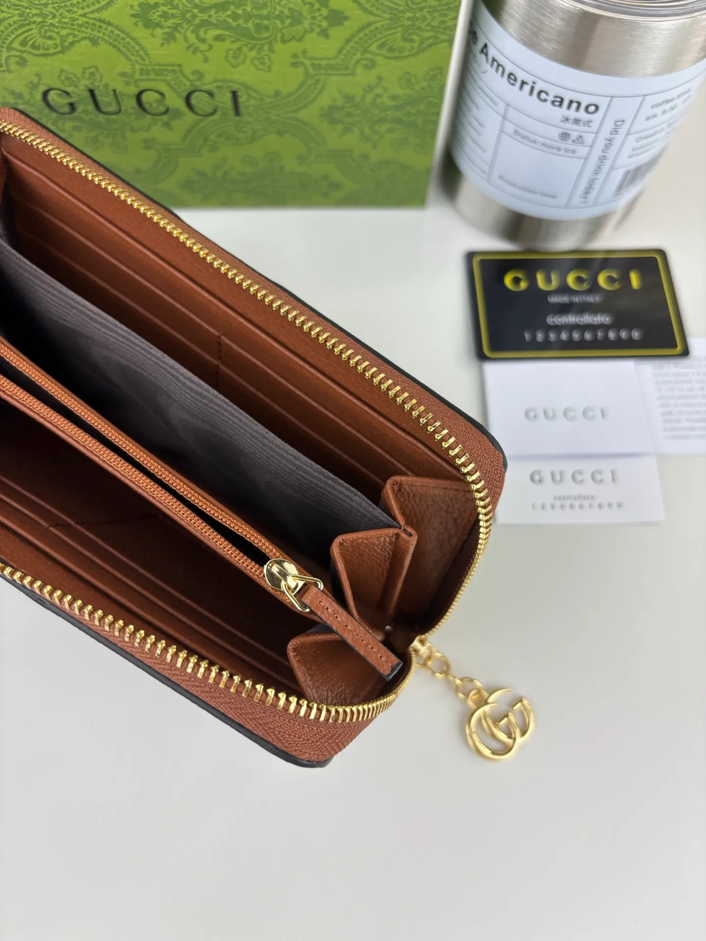 💰170 GUCCl full zipper wallet. The GG logo, which began to be used in the 1970s, evolved from the early Gucci diamond pattern that began in the 1930s. This full-zip wallet combines iconic graphics with striped webbing, a timeless combination that pays homage to Gucci's roots. Brown/ebony GG Supreme canvas with brown leather trim, gold-toned hardware Double G, 12 card compartments, 3 bill compartments, zipped coin pocket, full zip closure. Style number: 523154 Size: 19cm x 10cm x 2.5cm Color: blue small G/brown on cloth