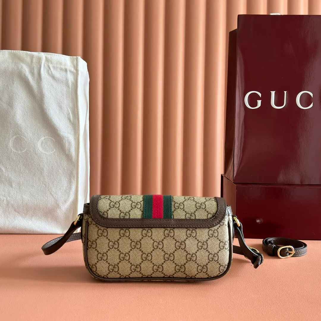 p960. 💋💋💋"With full set of original counter packaging" [New Product] The Ophidia series ingeniously interprets novel silhouettes and functions, with iconic beige and brown colors, creating a bag with soft texture and fashionable style. The flap is trimmed with signature webbing. Beige and dark brown GG monogram coated fabric Brown leather trim Light gold tone hardware Green linen cotton blend lining Double G Web strap Interior: Two card compartments Adjustable leather shoulder strap Height: 50 cm Magnetic snap closure Ident.: 838471. Dimensions: 19.5cm (width) x 11cm (height) x 6cm (depth) Weight: approx. 240g Color: Brown/PVC. Made in Italy