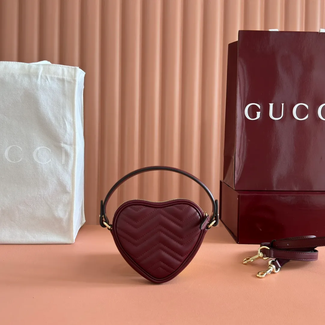 p940. 💋💋💋"With full set of original counter packaging" [New product] This GG Marmont series mini handbag has a playful and cute heart-shaped silhouette and is crafted from soft Gucci Ancola red V-shaped Matelassé cow leather. The bag has a simple and compact shape and is equipped with the iconic Double G accessories in light gold tones. Gucci Rosso Ancora red quilted V-shaped calfskin leather Light gold tone hardware Red taffeta lining Double G Interior: One card compartment Carry handle (8 cm height) Detachable and adjustable shoulder strap (48 cm height) Zip closure Weight: approx. 0.162 kg Ident number: 837753. Dimensions: 13.5cm (width) x 11.5cm (height) x 2.5cm (depth) Color: Red full leather. Made in Italy