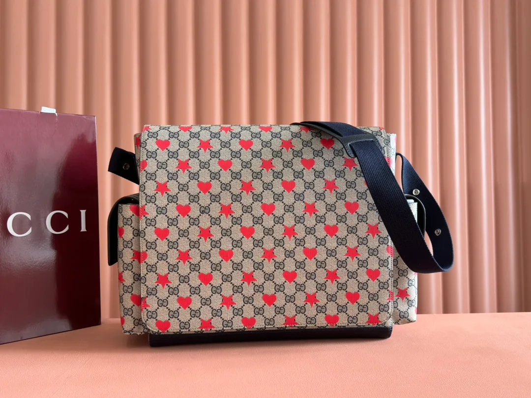 p1140. 💋💋💋"With full set of original counter gift bag packaging" [New Product] The children’s Cruise 2025 series presents a series of well-loved themes, including iconic logo details. Made from GG Supreme canvas, this diaper bag displays an all-over star and heart print and features dark blue bands. Beige and blue GG Supreme canvas. Dark blue ribbon decoration. All-over star and heart print. Washable nylon lining. Interior: 3 stretchy open pockets, 2 stretchy water bottles. Model: 811491. Size: 45x32x15cm Color: star dark blue/pvc. Made in Italy