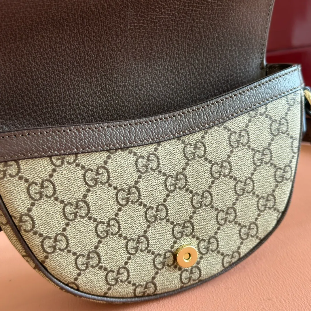 p1000💋💋💋"With full set of original counter packaging" [New Product] The Ophidia series ingeniously interprets novel silhouettes and functions, with iconic beige and brown colors, creating a bag with soft texture and fashionable style. The crescent-shaped flap is trimmed with signature webbing. Beige and dark brown GG monogram coated fabric Brown leather trim Light gold-toned hardware Green linen-cotton blend lining Double G Web strap Interior: One card compartment Adjustable leather shoulder strap Height: 51 cm Magnetic snap closure Ident.: 838476. Dimensions: 20cm (width) x 13cm (height) x 4.5cm (depth) Weight: approx. 377g Color: Brown/PVC. Made in Italy