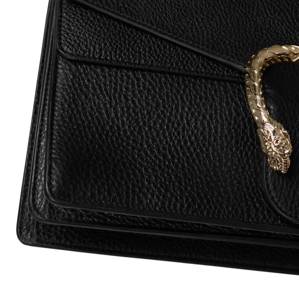 This piece is crafted from black leather, with double tiger head locks and a flip design. The length can be adjusted freely by sliding the chain to create different styles. Black leather Light gold-tone hardware Black microfiber lining Pin buckle, side opening Double tiger head lock closure Internal zip compartment Flap pocket Double baffles Sliding chain strap can be adjusted to a shoulder strap with a height of 43 cm, or a top handle with a height of 24 cm. Weight: about 0.8 kg Model: 795005. Dimensions: 28cm (width) x 16cm (height) x 10.5cm (depth) Color: Black Full leather: Original leather. Made in Italy