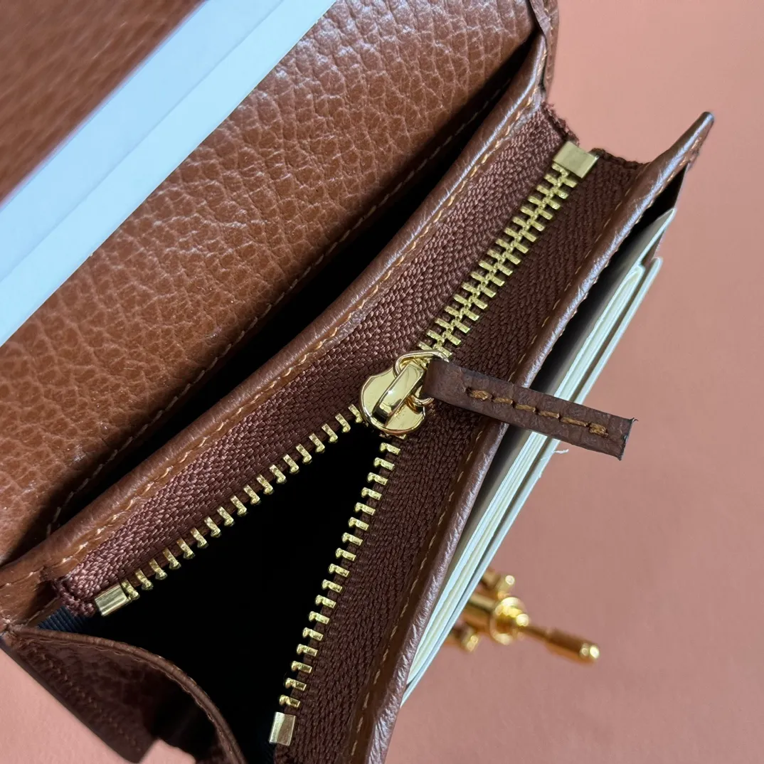 p460. 💋💋💋 [Original leather accessories 🌈 Equipped with full counter packaging] 🔥🔥 The jackie1961 series launches a compact and noble new card holder shape. Gold-toned push-lock closure, washed denim give the entire design a timeless and elegant feel, five card compartments, two flat pockets, one zip pocket, and interior open pocket. Dimensions: 11×8.5x3. Model: 645536.