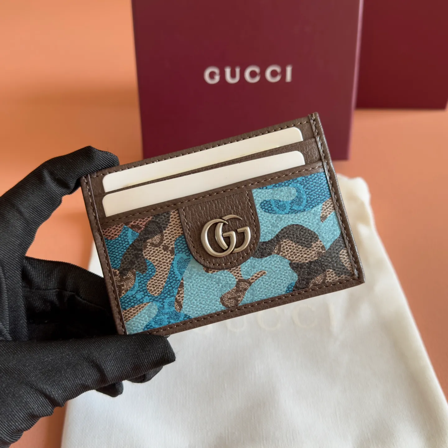 p300. 💋💋💋【With full set of original counter packaging】Vivid camouflage combined with unique color matching, a new interpretation of the classic GG pattern. This card holder is made of coated fabric with a marbled GG monogram pattern and features Double G details. Green and yellow camouflage marbled GG monogram coated fabric Brown leather trim Palladium tone hardware Brown taffeta lining Double G Web detail Interior: 1 open compartment Exterior: 4 card compartments Ident No.: 834795. Dimensions: 11cm (width) x 7cm (height) Weight: about 30g Color: blue camouflage/PVC. Made in Italy